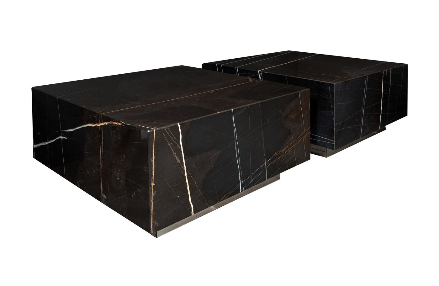 Black marble Cocktail Tables on bronze mirror bases.