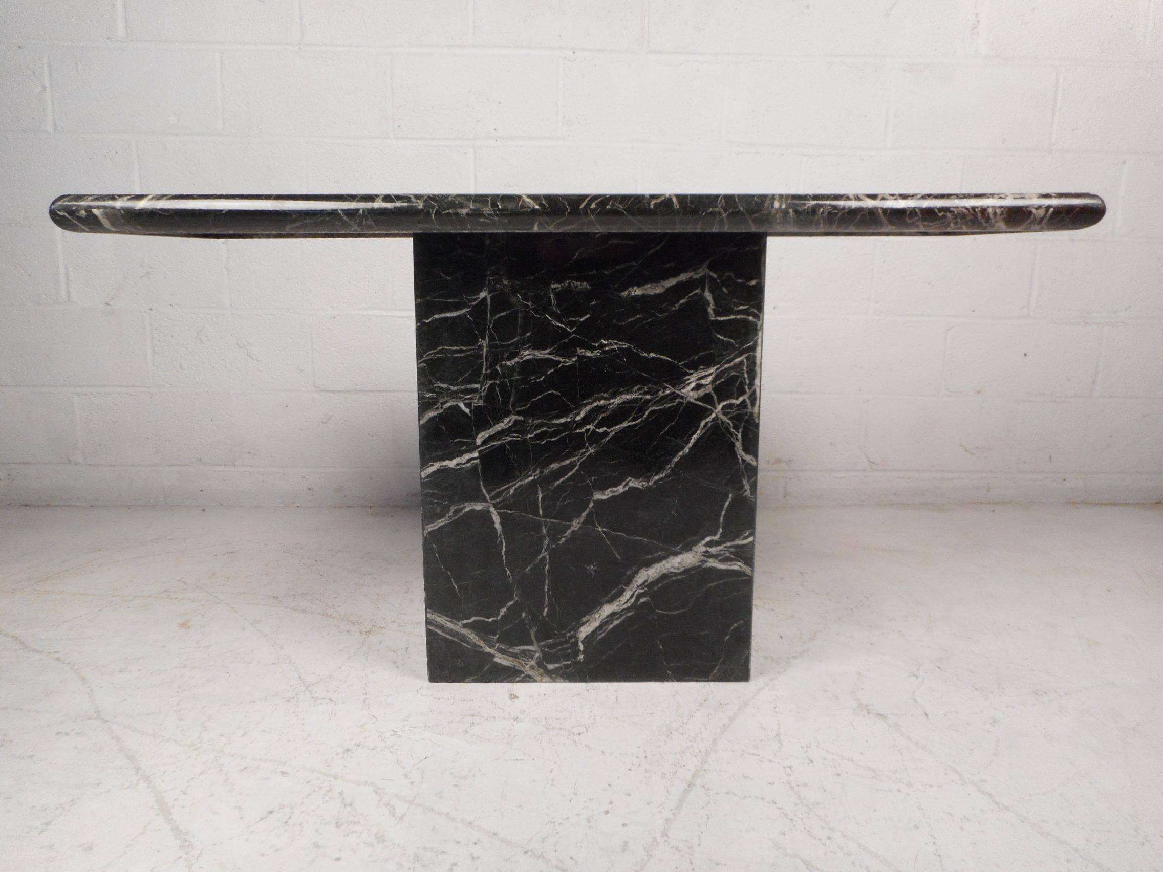 Stylishly simple midcentury console table with a black marble pedestal base and tabletop. Beautiful veining in the stone. Perfect for use as a hall or sofa table, sure to compliment any modern interior. Please confirm item location with dealer (NJ