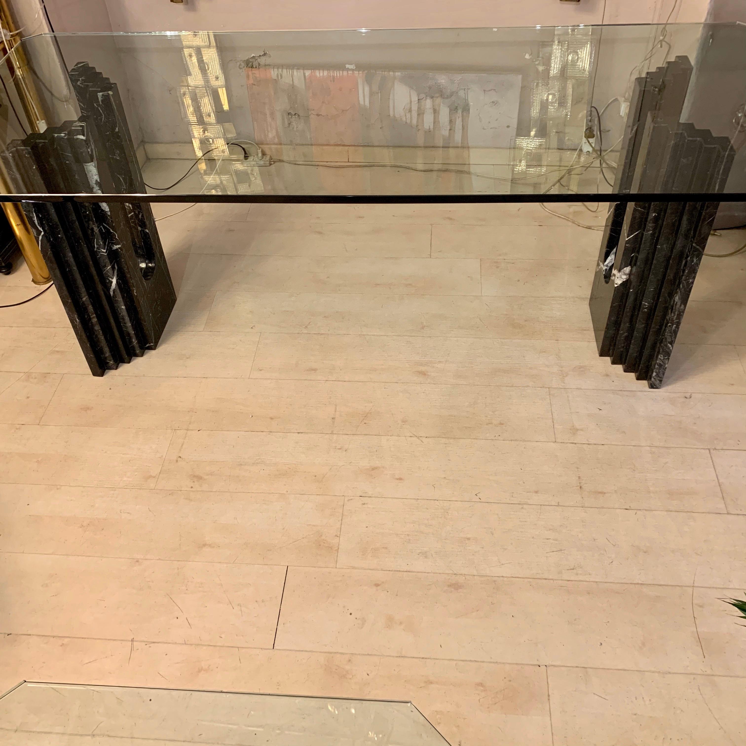 Black marble dining table with crystal top, 1970s.
The marble block bases support a thick (cm 1.8) crystal top with hexagonal shape.