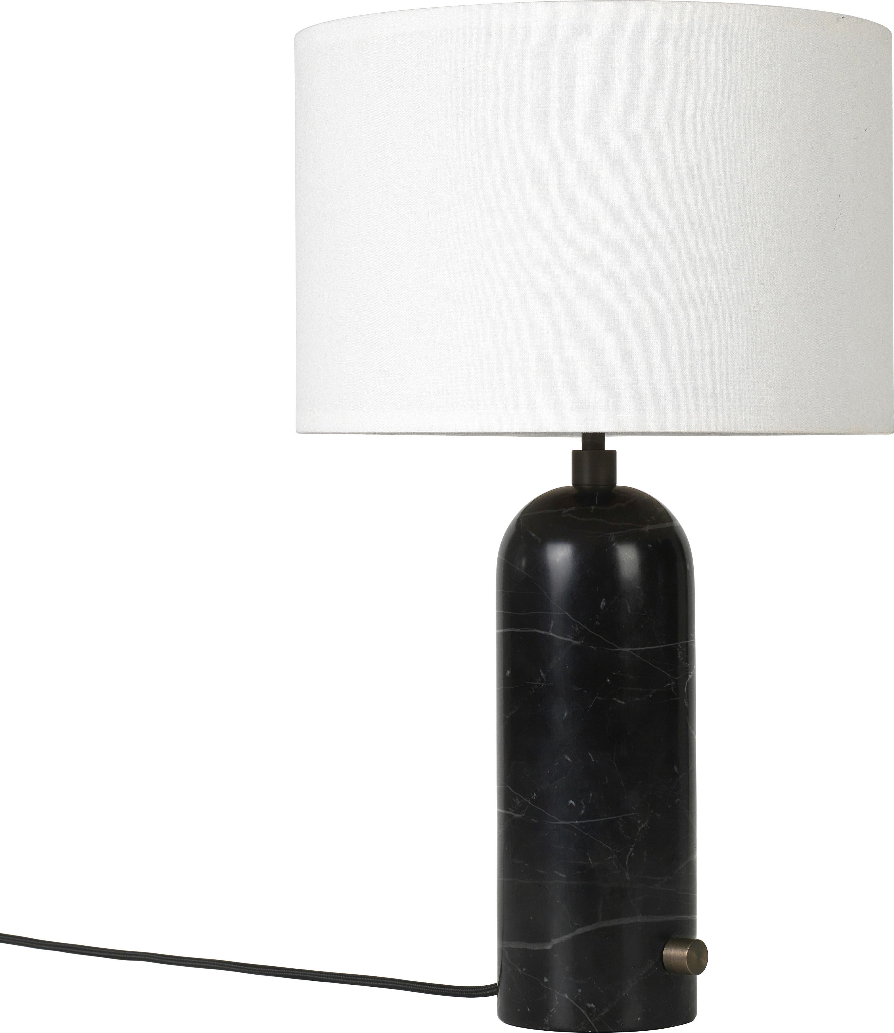 Large 'Gravity' marble table lamp by Space Copenhagen for Gubi in black.

Executed in solid marble with a canvas or white textile shade perched atop its stem, the Gravity table lamp designed by Space Copenhagen for GUBI contrasts strength and