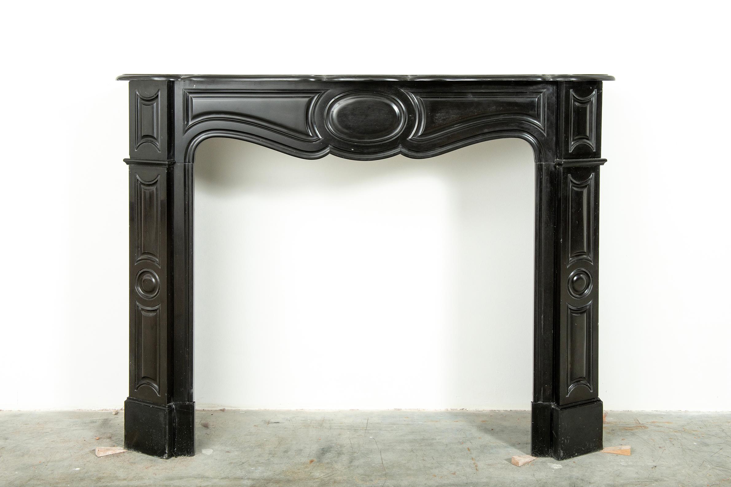 Antique French fireplace in deep black Belgian marble

Lovely petite Louis XV style fireplace great deep black coloring and friendly decorations.

Nice sculpted shelf above a paneled freeze with a central circle between two paneled enblocks above