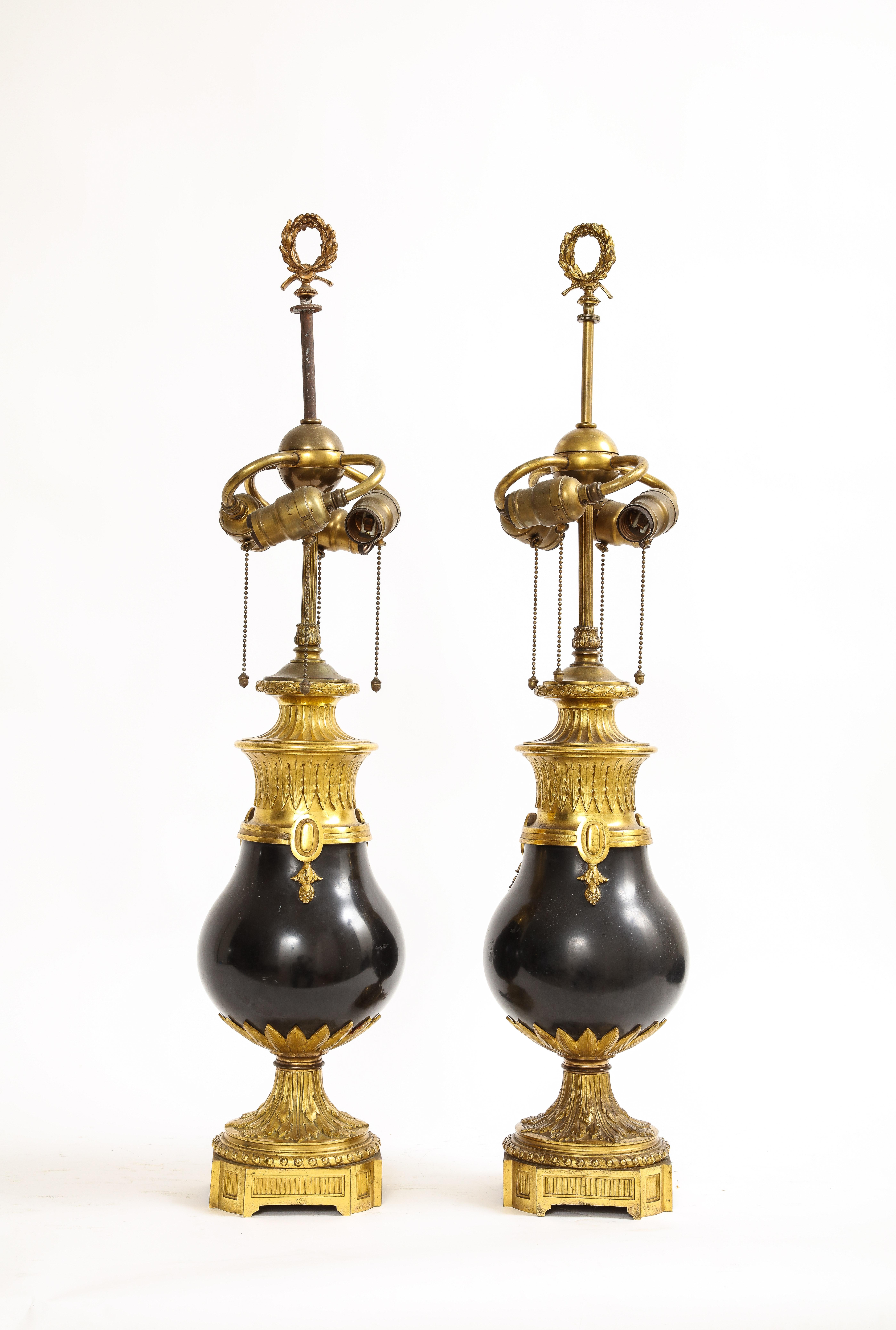 A Pair of Black Marble Ormolu Mounted Caldwell Lamps made in the late 1800s.

An awe-inspiring pair of lamps that harken back to the refined craftsmanship of the 1800s. These exquisite pieces feature black marble, meticulously shaped to resemble