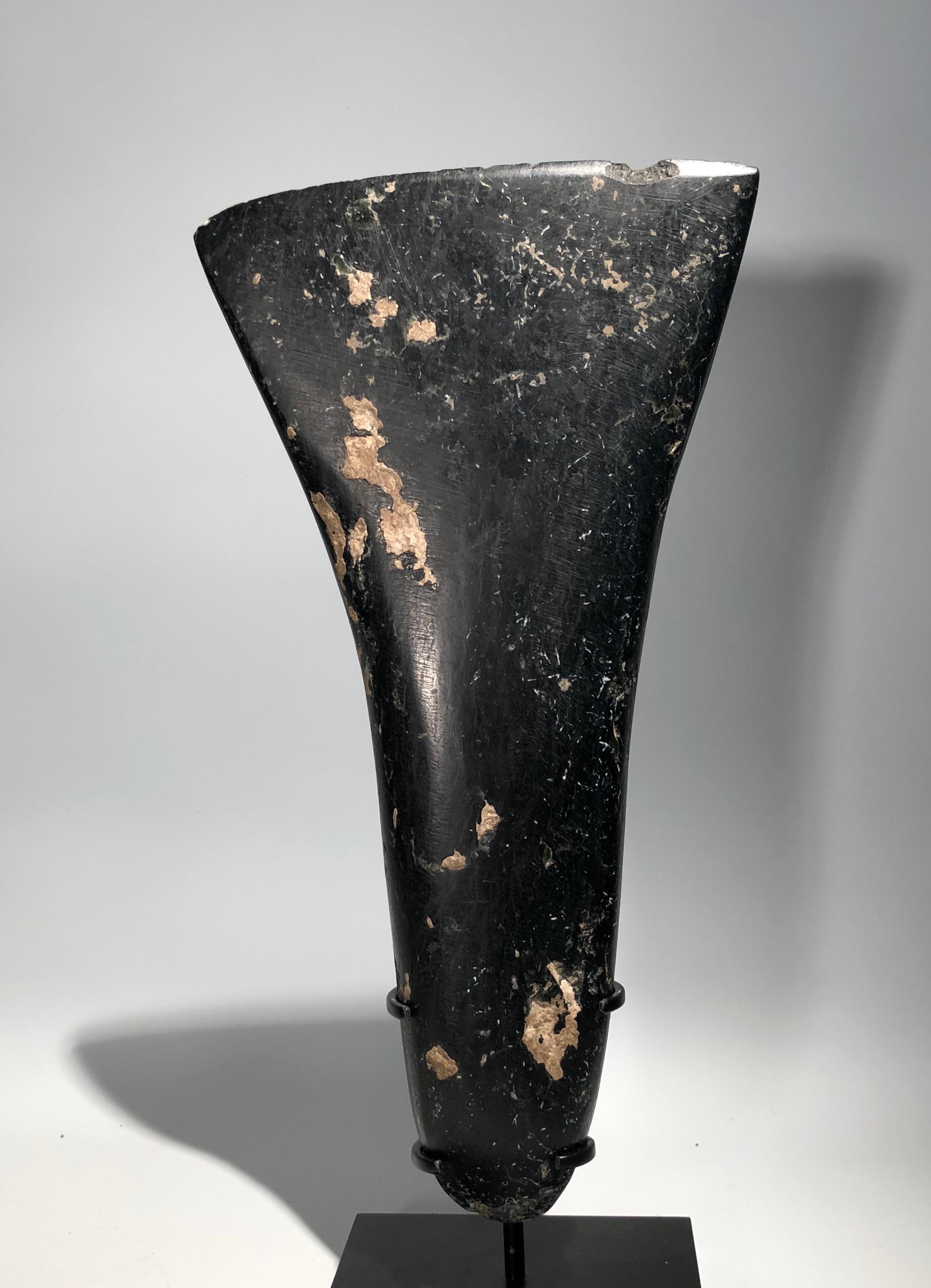 Highly polished black marble prehistoric Western Asiatic ceremonial axe. Probably nowadays Russia, 2nd millennium BC. This elegant and impressive piece that could very well have been sculptured by a contemporary artist can fill in its simplicity a
