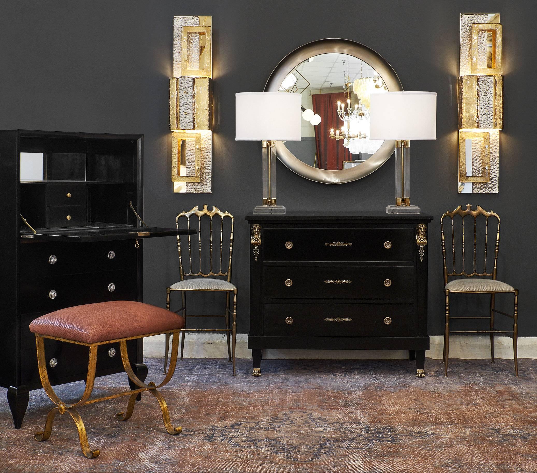 A charming Empire style chest with black marble top. This French antique piece is made of mahogany and features an intact marble slab, three dovetailed drawers, bronze hardware, and tapered columns with finely cast “cariatides a la Grecque” and