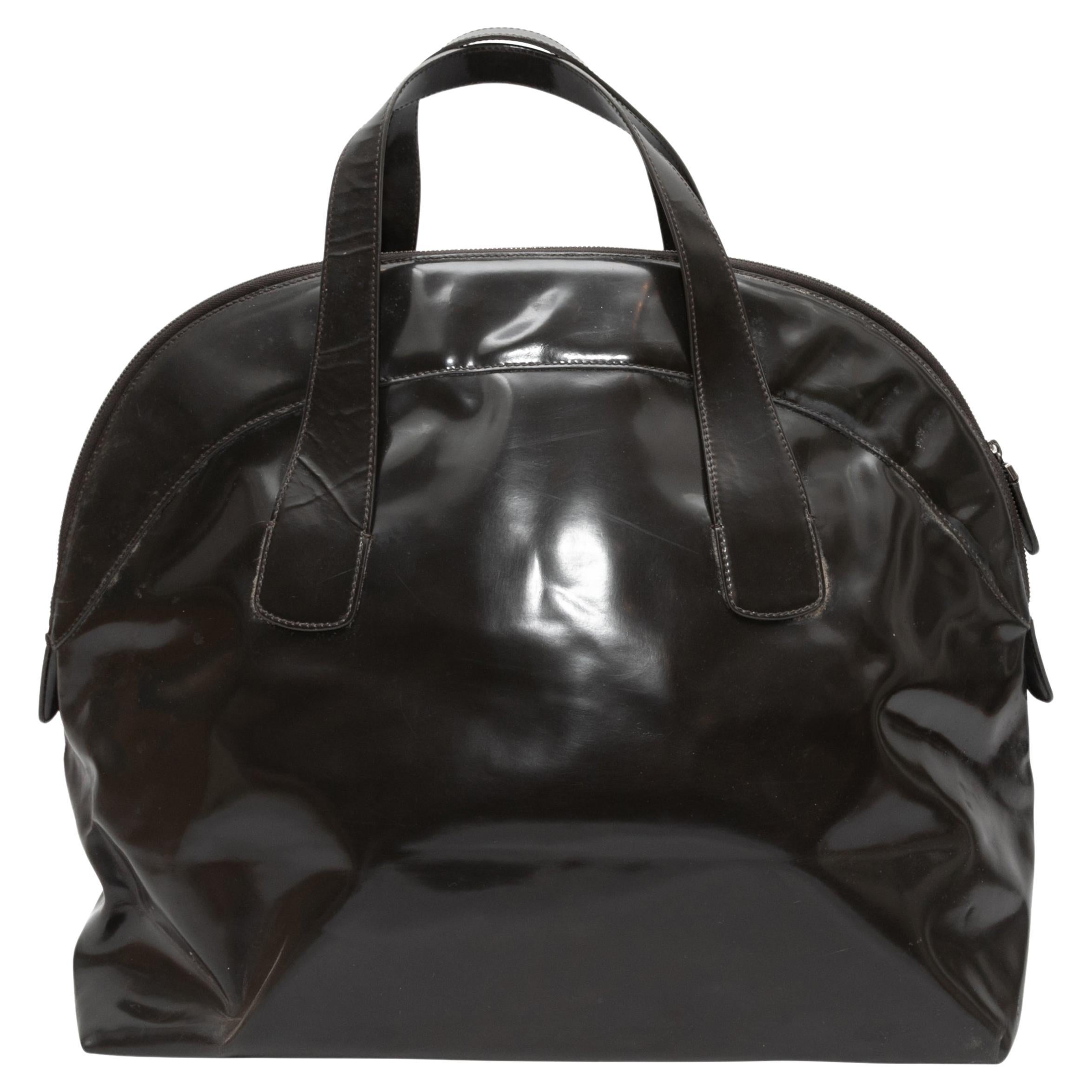 Black Marni Patent Top Handle Bowler Bag. This bag features a patent leather body, dual flat top handles, and a top zip closure. 22.5