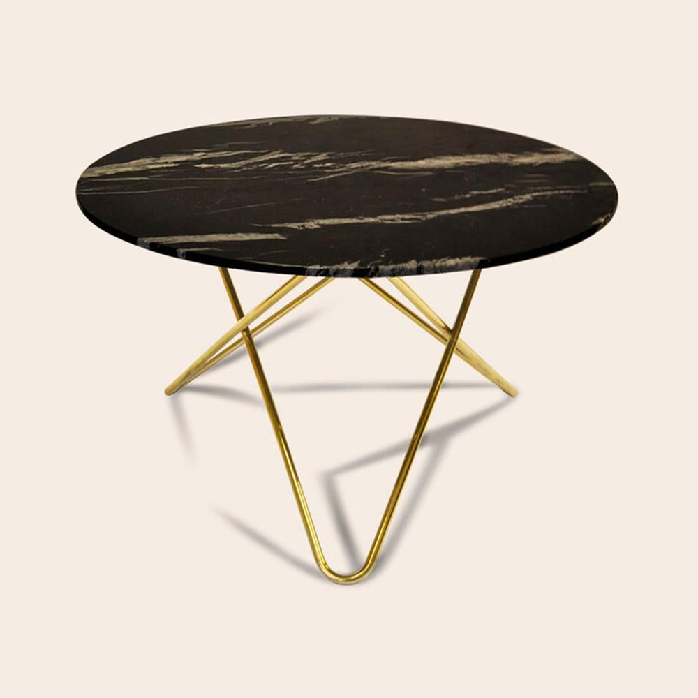 Black Marquina marble and brass big O table by Ox Denmarq
Dimensions: D 120 x H 72 cm
Materials: Brass, black Marquina Marble
Also available: Different marble and frame options available

OX DENMARQ is a Danish design brand aspiring to make