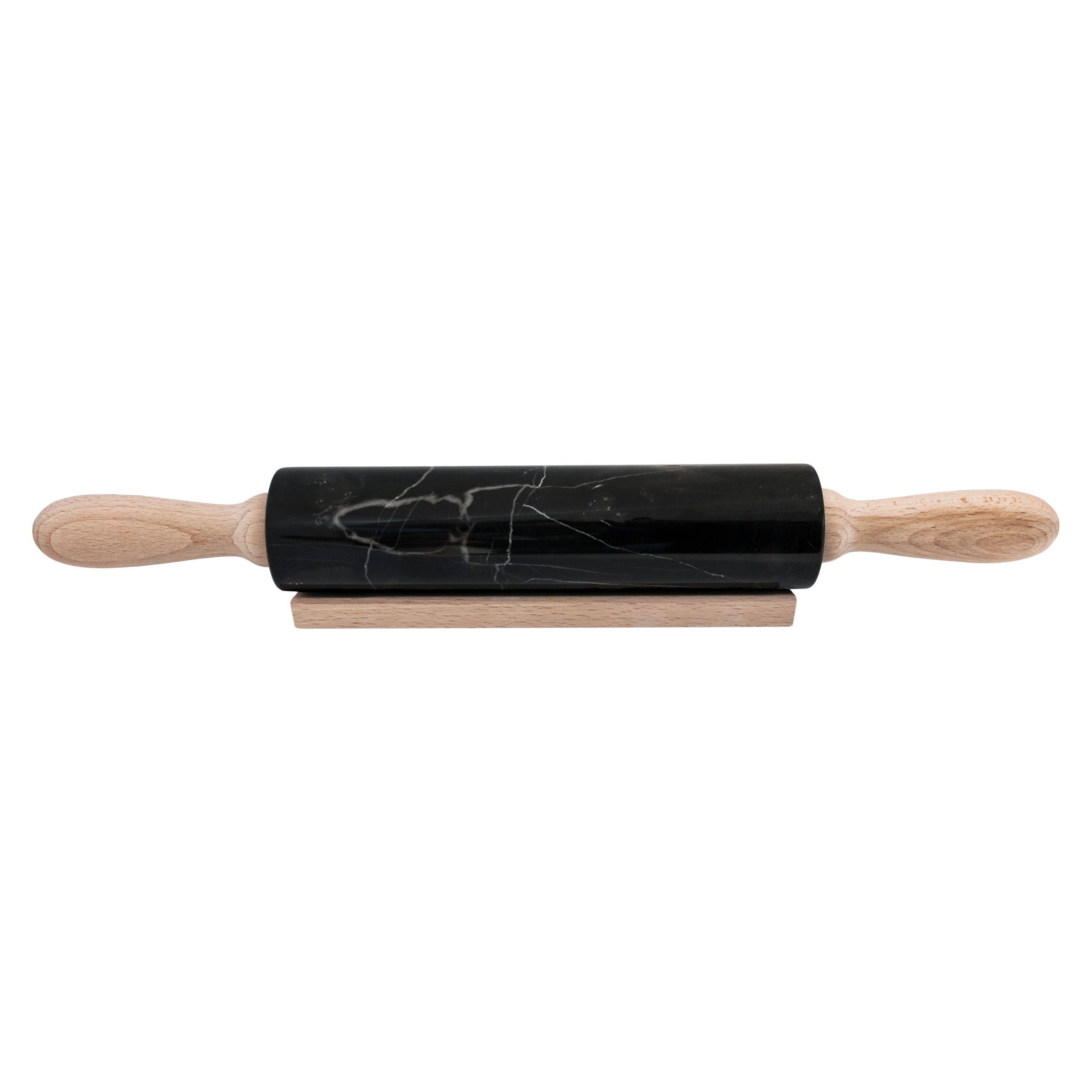 Black Marquina marble rolling pin with wooden handles. It is assembled manually. Each piece is in a way unique (every marble block is different in veins and shades) and handmade by Italian artisans specialized over generations in processing marble.