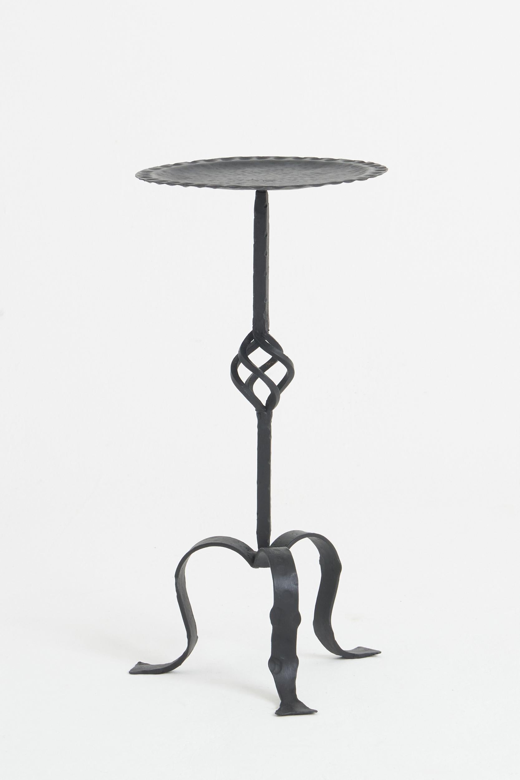 A black enamelled wrought iron martini table.
Spain, mid 20th Century
62 cm high by 30 cm diameter