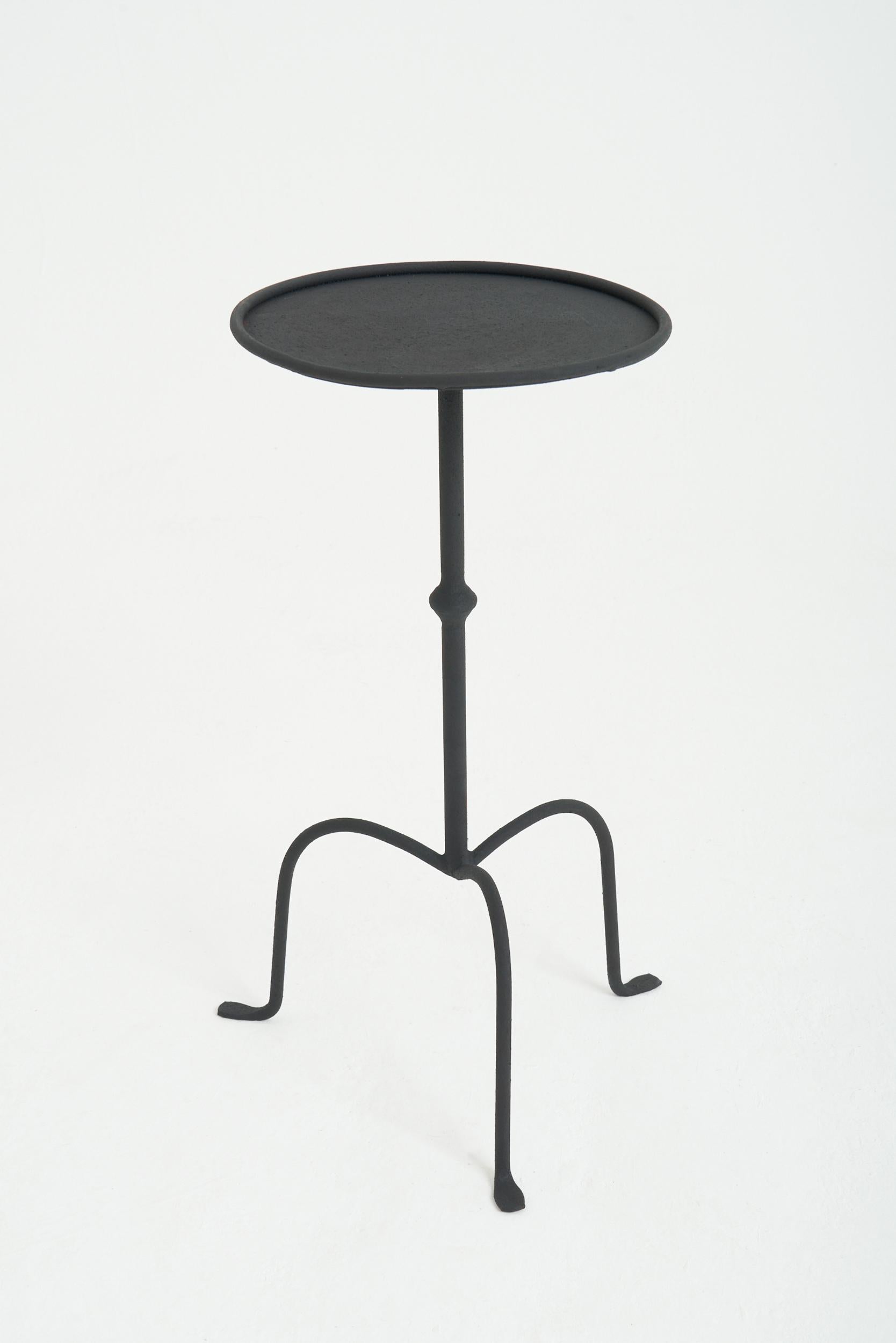A black patinated wrought iron martini table.
Spain, contemporary
58.5 cm high by 28 cm diameter 
