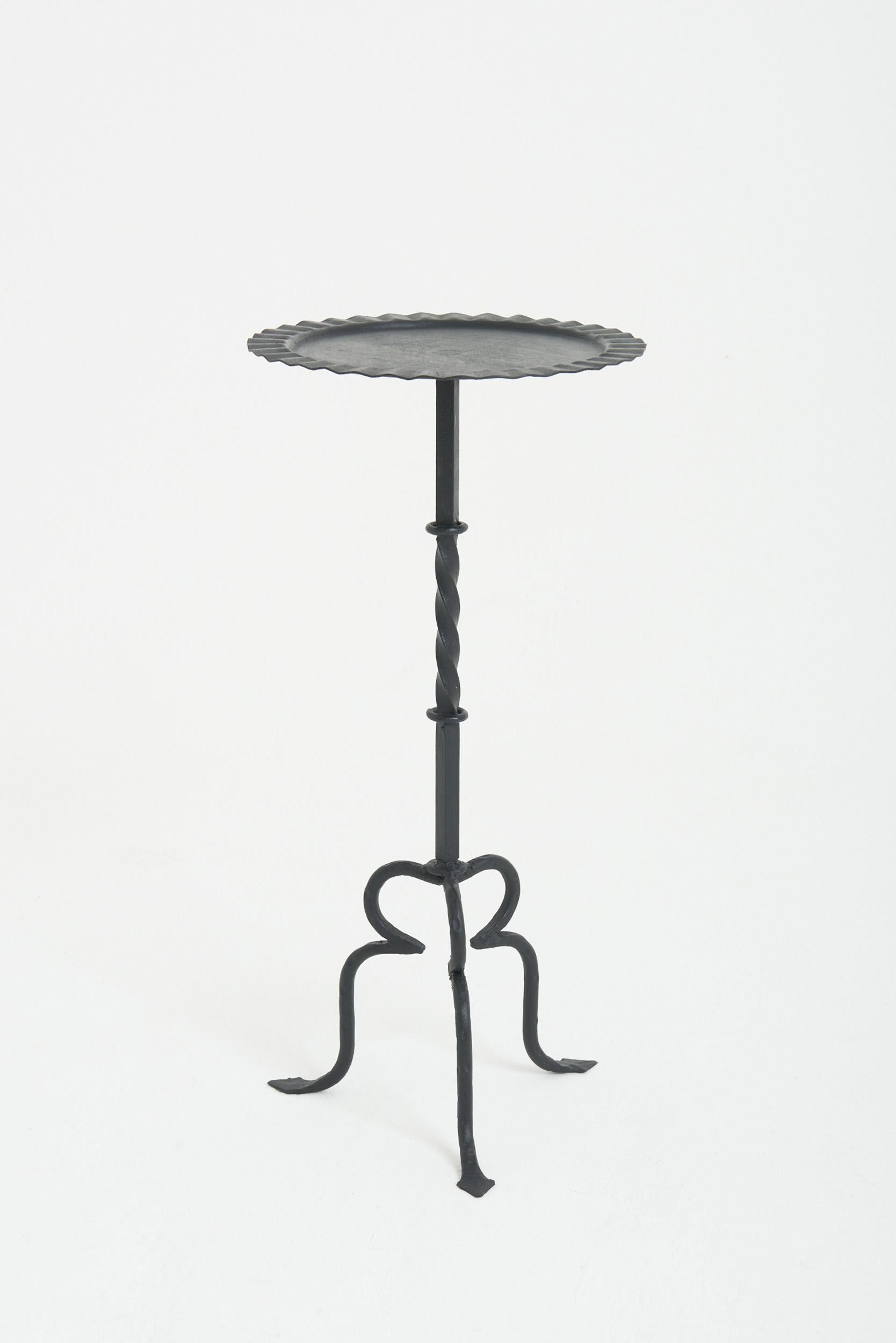 A black patinated wrought iron martini table.
Spain, third quarter of the 20th Century
61.5 cm high by 29.5 cm diameter