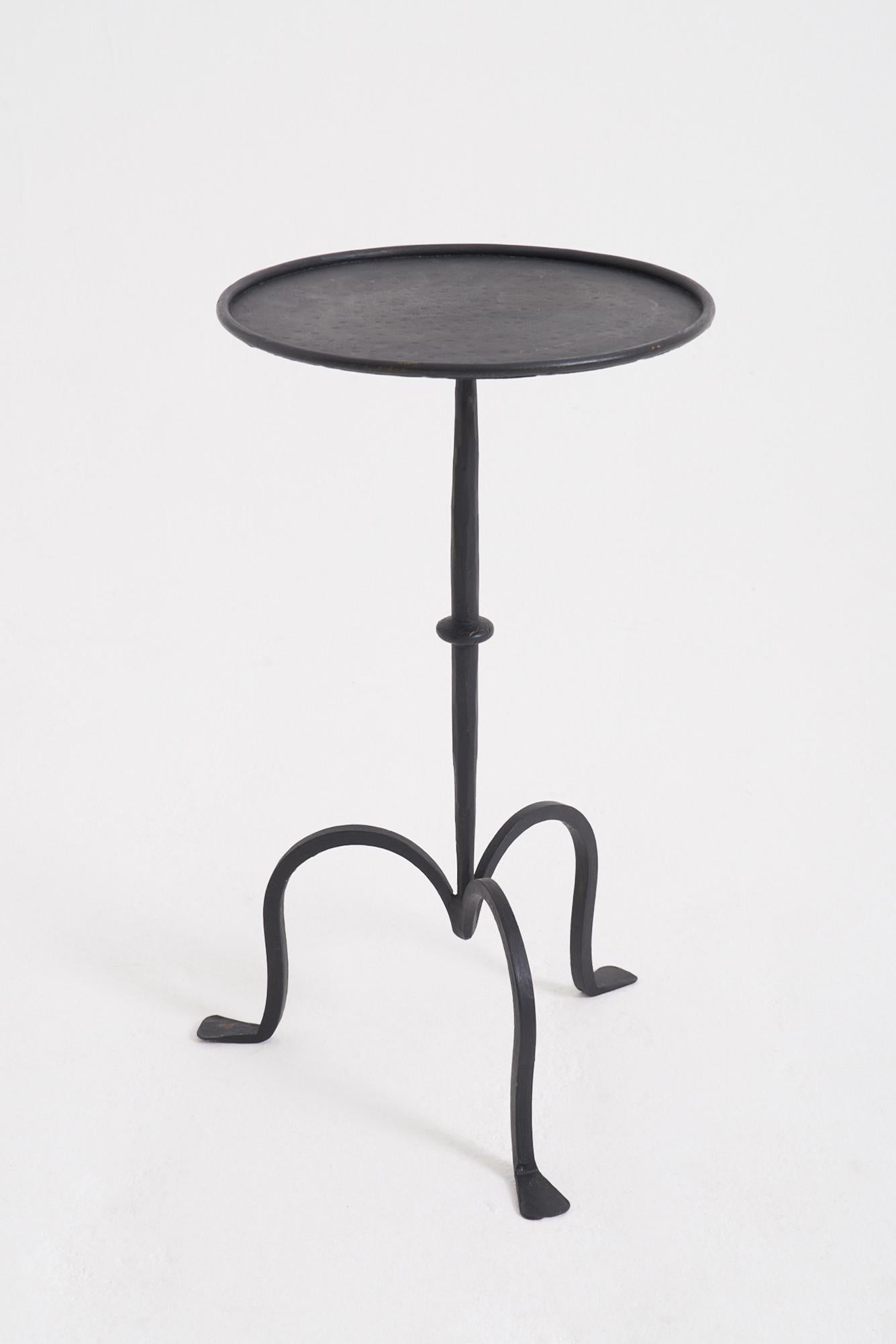 A black patinated wrought iron martini table
Spain, third quarter of the 20th Century
54.5 cm high by 31 cm diameter