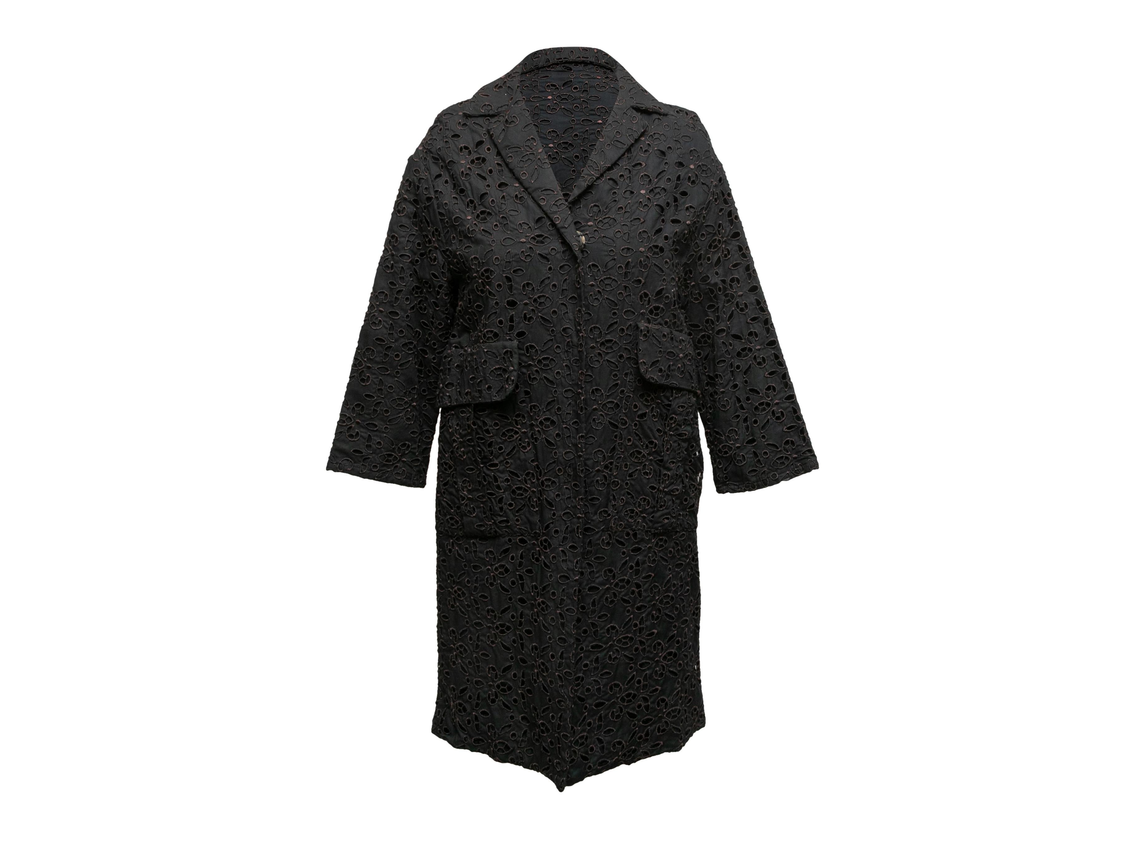 Black and brown eyelet lace coat by Maurizio Pecoraro. Notched collar. Dual hip pockets. Front closures. 36