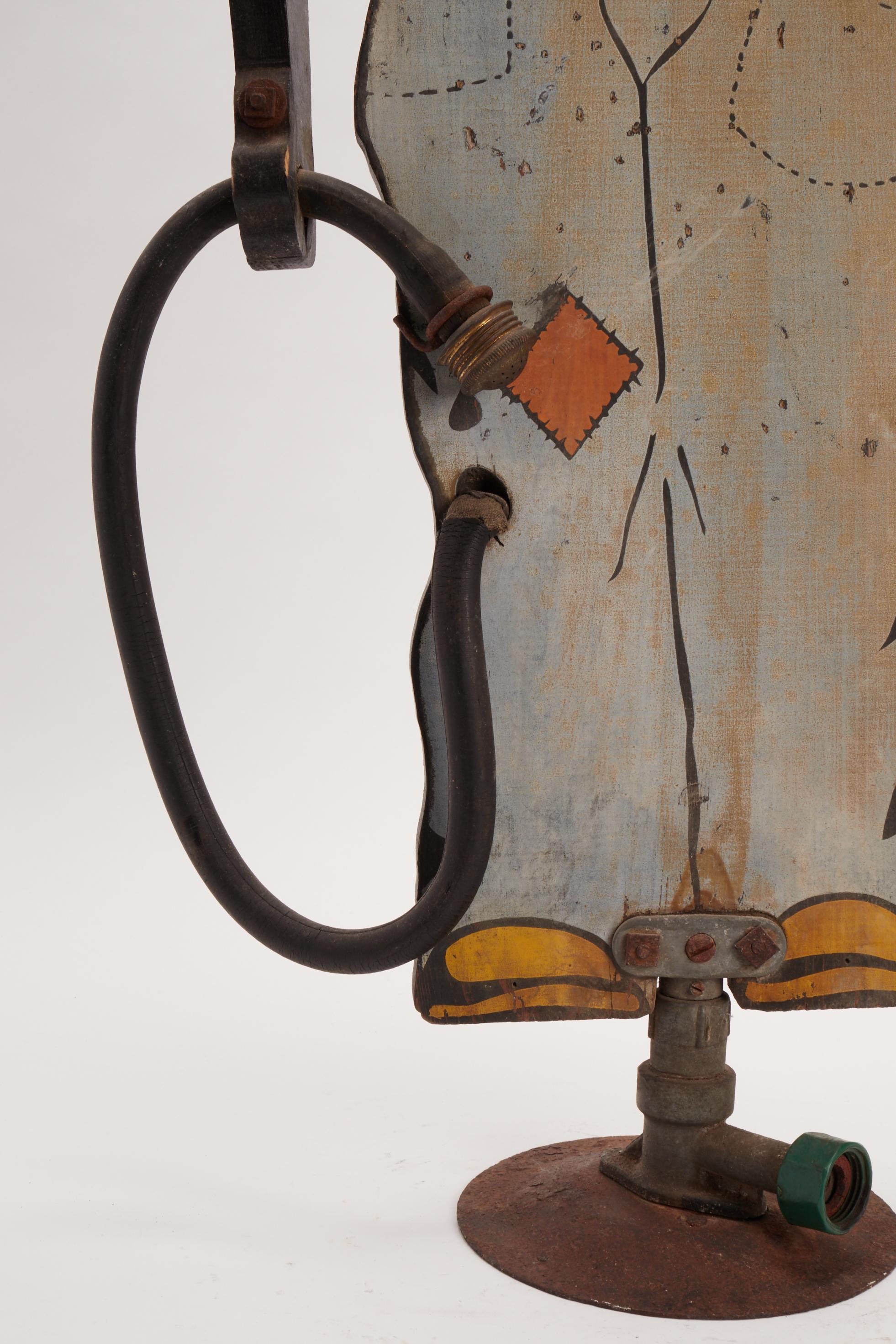 Black Americana (Black Memorabilia). A garden sprinkler made by Firestone Tire and Rubber Company colored wooden and tin plate. The right-hand holds the hose, USA, 1915 ca.