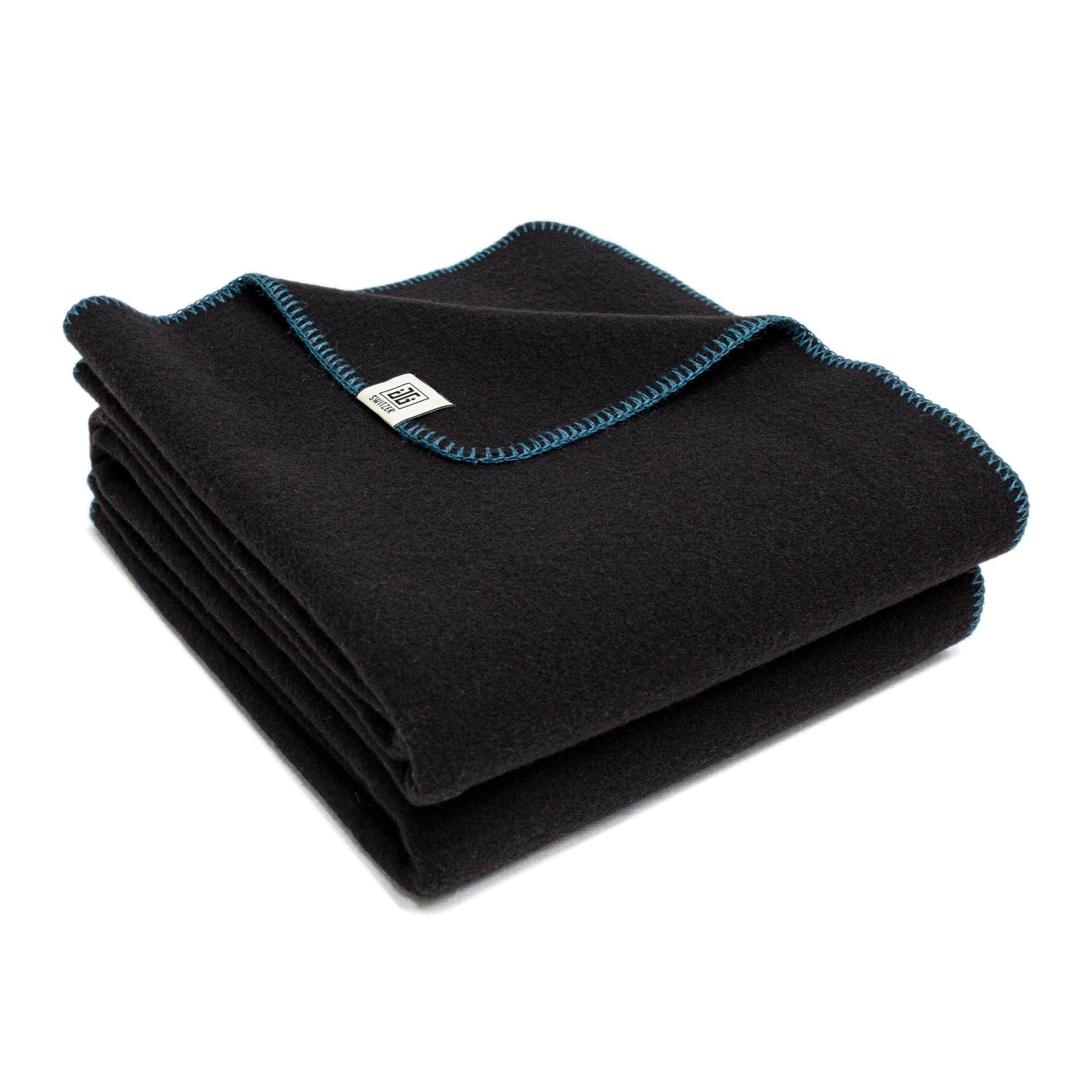 The Portia is our warmest, hardiest 100% Merino throw, milled in England from soft and high quality raven black Merino wool. Black wool is finished with fine hand sewn detailing blanket stitch of Alpaca and Silk yarn. Available in Blanket stitch of