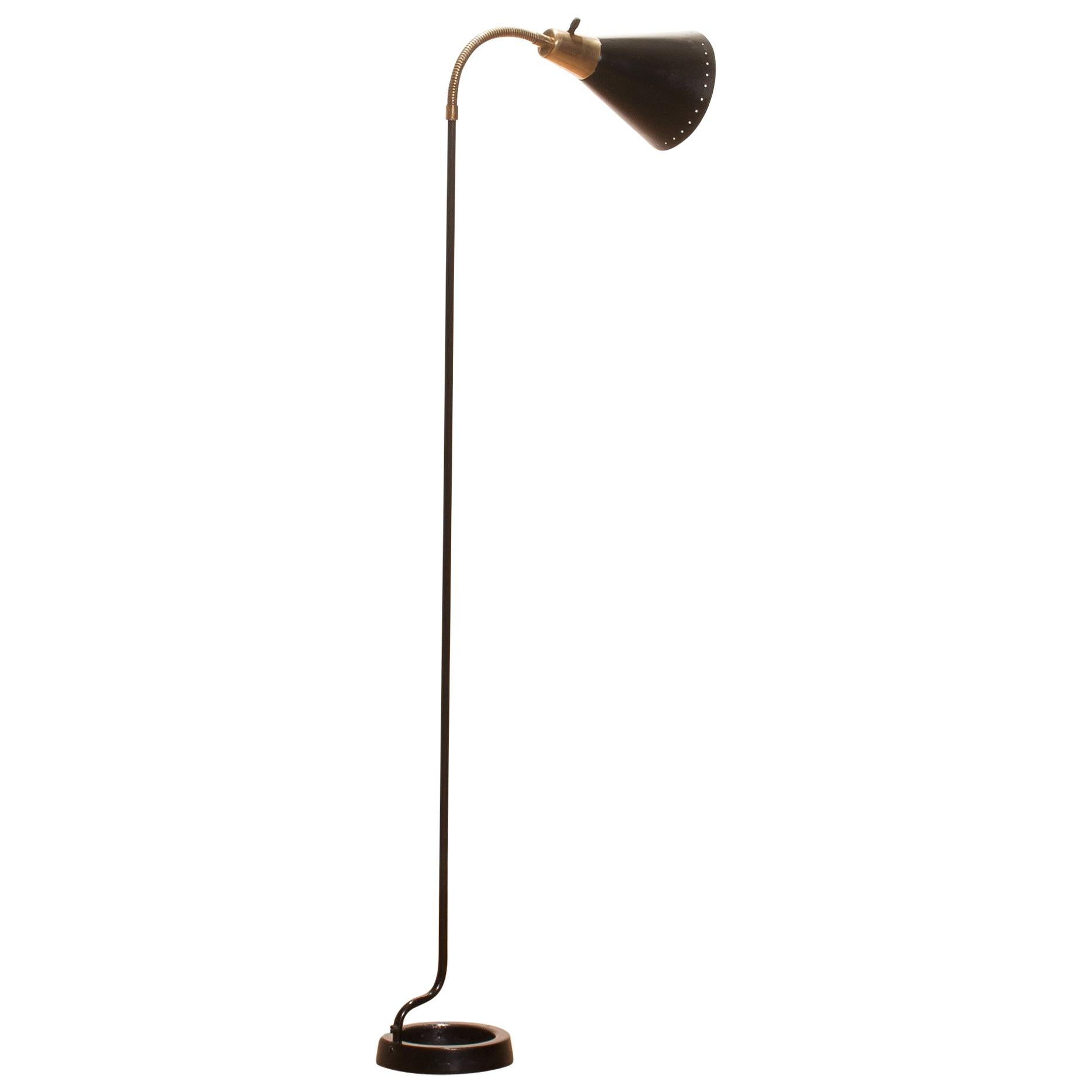 Beautiful floor lamp made in Sweden.
This lamp is made of black metal with brass details and has a very rare stand.
It has a perforated shade which gives a wonderful shining.
It is in an original and working condition.
Period 1940s.
Dimensions: