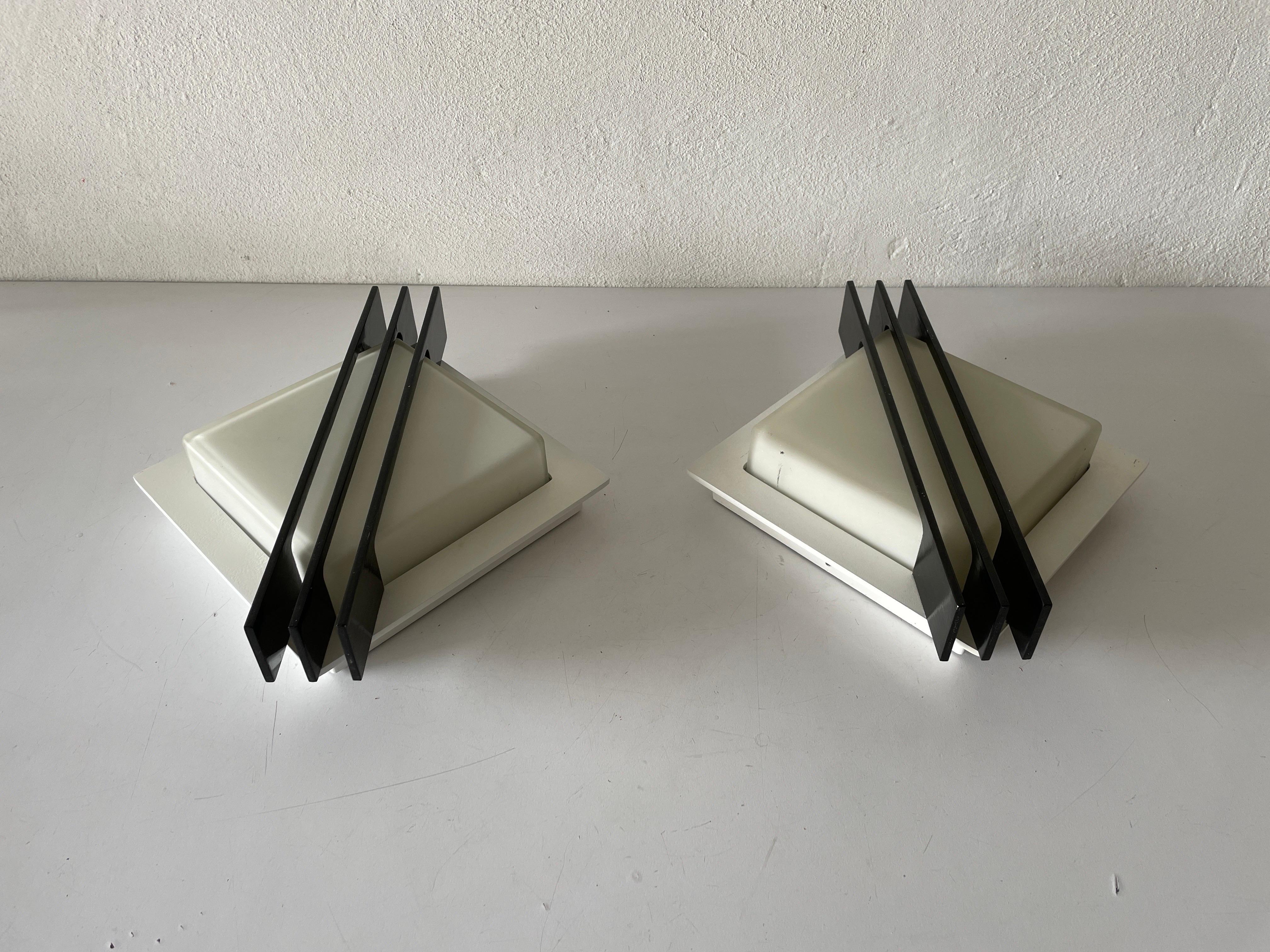 Rare square design black metal and glass pair of flush mounts or sconces by BEGA, 1960s, Germany.

Very elegant and Minimalist wall lamps
Lamps is in very good condition and very heavy

These lamps works with 13W Osram Dulux D. light bulbs.