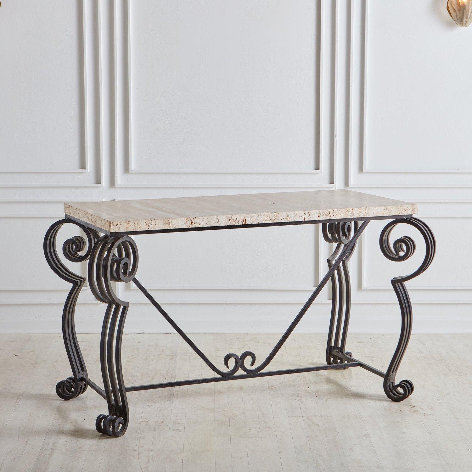 A vintage Italian desk or entryway table featuring a black metal base with four curved legs, each constructed with three square tubular rods. This desk has a rectangular 1.625” thick travertine top with beautiful taupe hues. We love the curl details