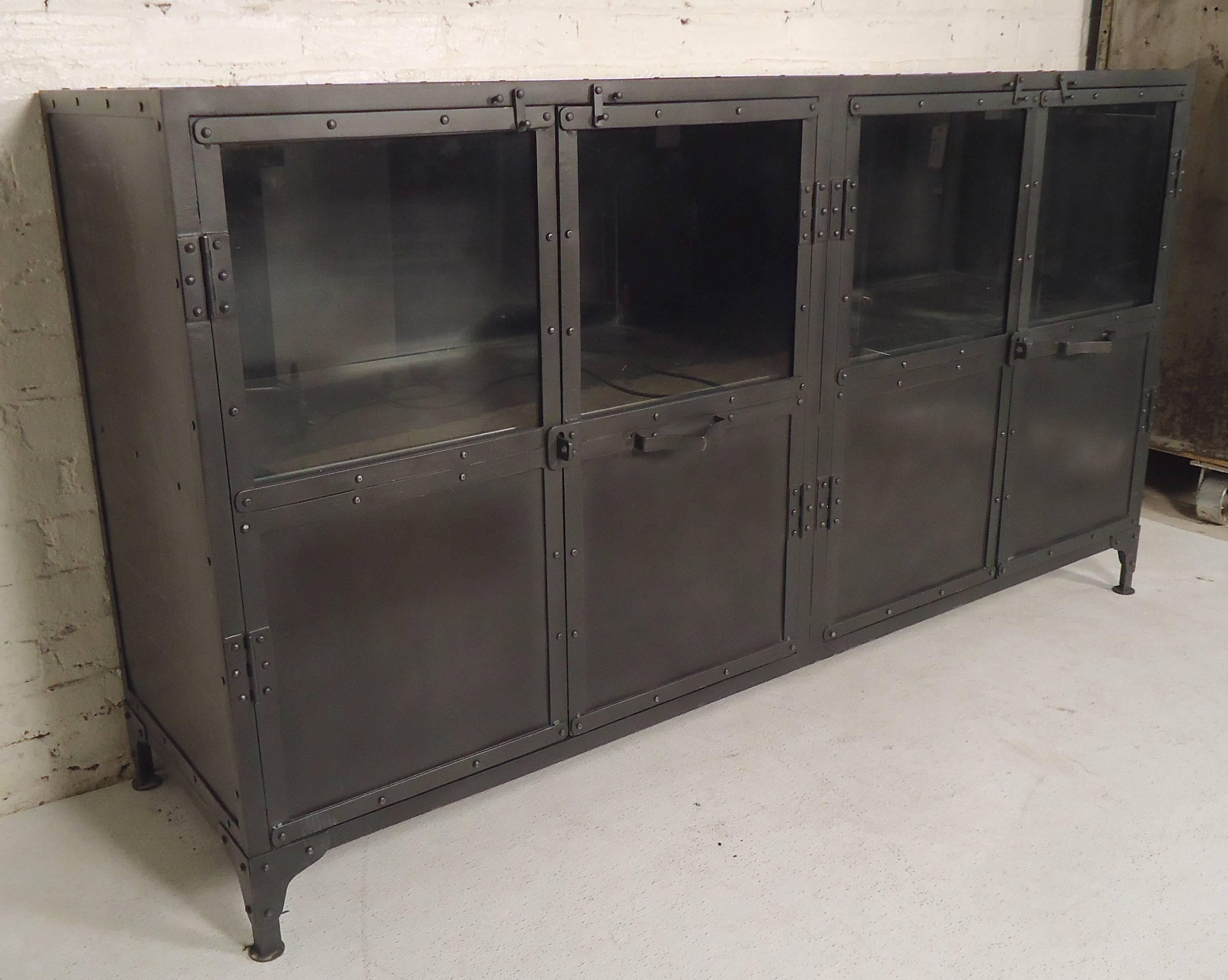 Heavy duty industrial style metal cabinet with glass top doors. Features handsome exposed rivets and metal latches for doors.

(Please confirm item location - NY or NJ - with dealer).
  