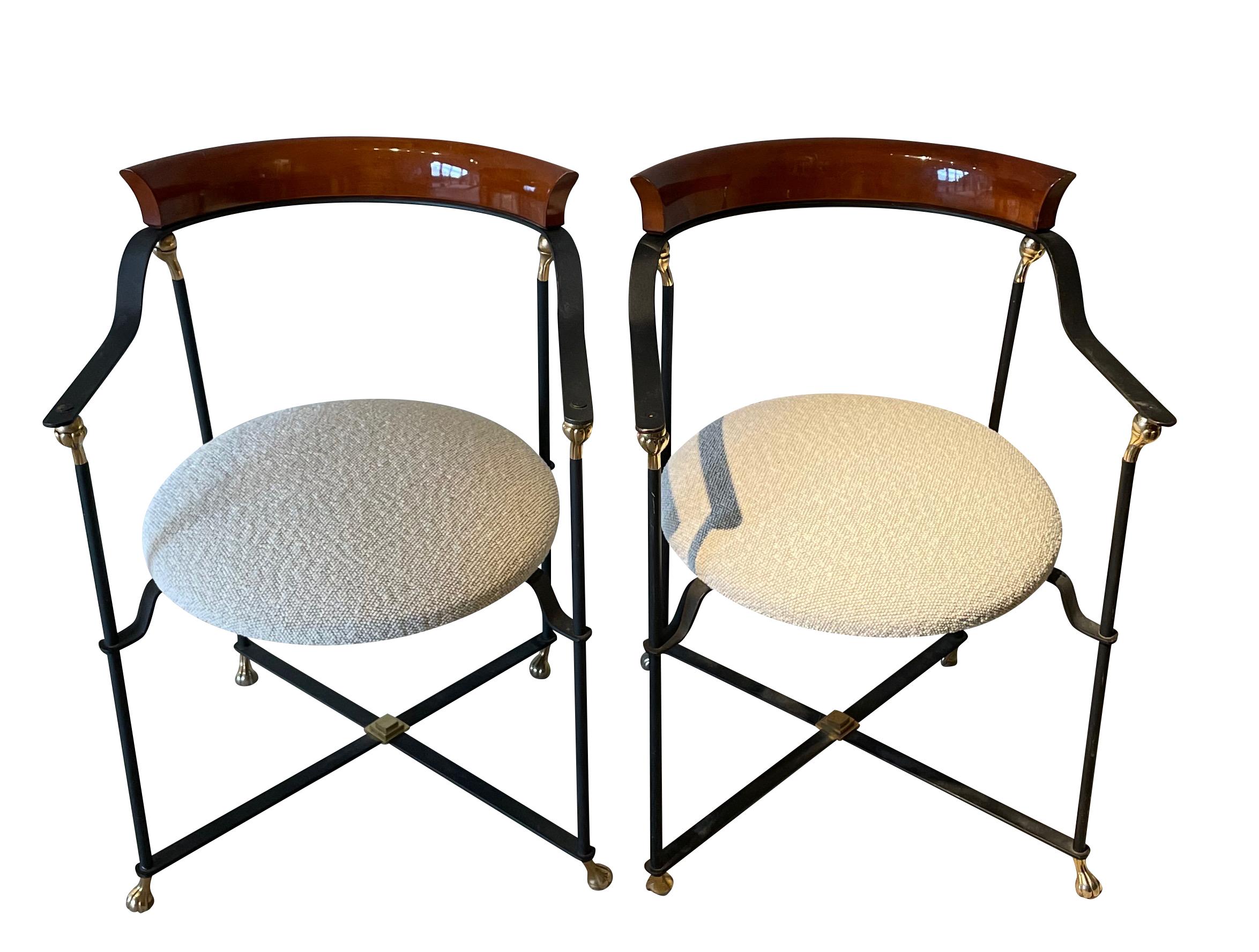1970's French pair black metal framed chairs with curved polished palissndre back support.
Decorative brass accents.
X base stretcher.
Seat recently reupholstered in boucle fabric.
Can be used as dining or pull up chairs.
Arm height 24