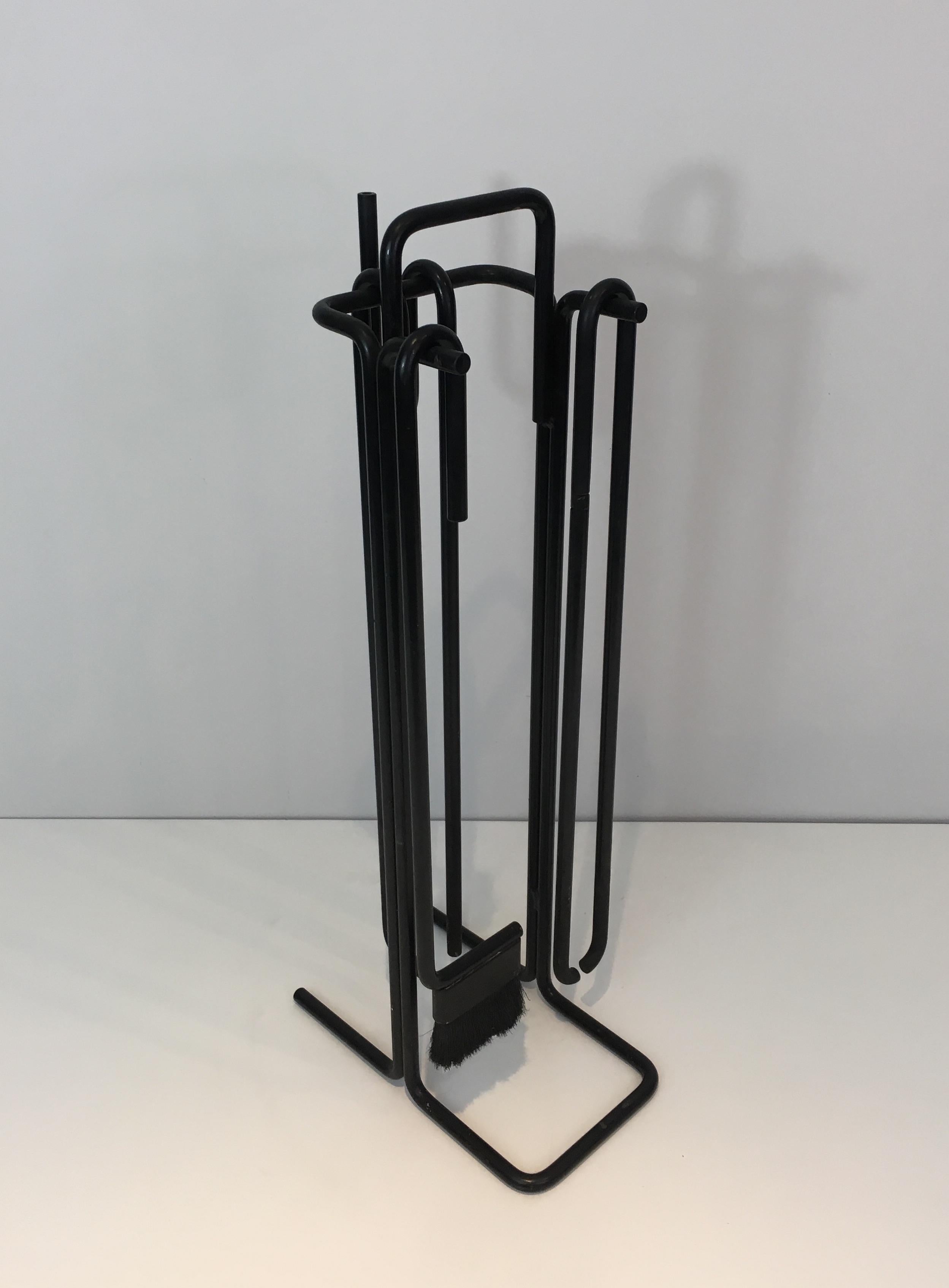 These modernist fire place tools on stand are made of black lacquered iron. The design of these fire place tools is very simple and modernist. They are French, circa 1970.
