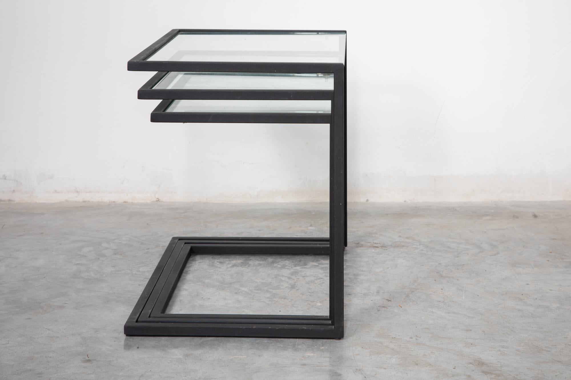 Rare Bauhaus style modernist nesting tables and clear glass top the frames are made of black lacquered metal.
The tables are in good original condition.