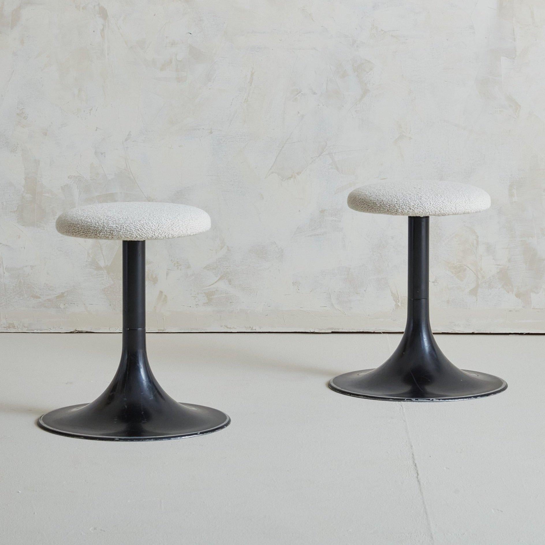 Mid-Century Modern black tulip base swivel stools with newly upholstered seats in white boucle fabric. The pedestal bases are generously proportioned and feature silver detailing along the edges. Sourced in France, 1970s. Priced Individually.
 

