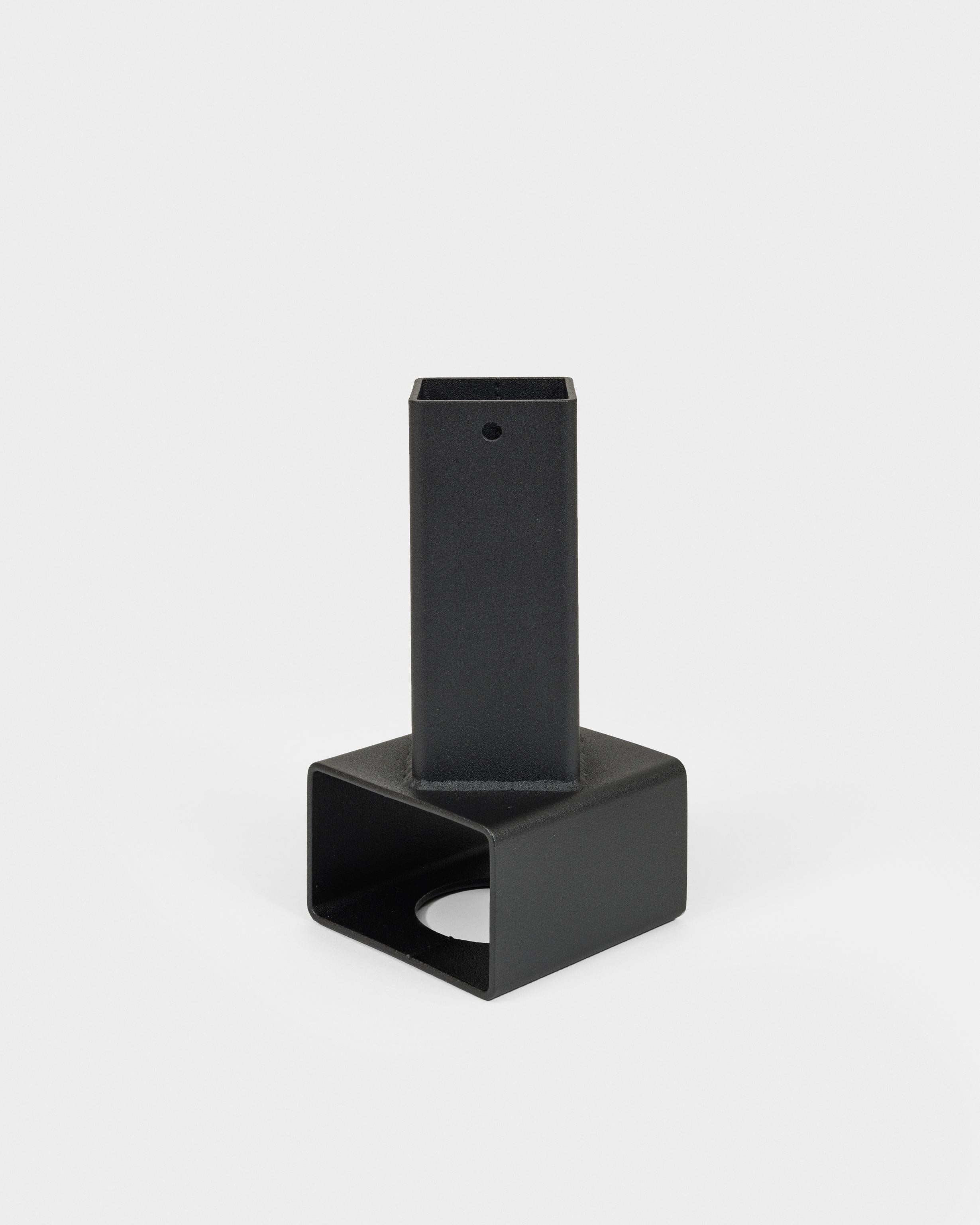 A welded steel vase with textured matte black powA welded steel vase with textured matte black powdercoat finish. The black metal vase combines brute industrialism with De-Stijl formalism. Pair with flowers and your favorite black metal album for a