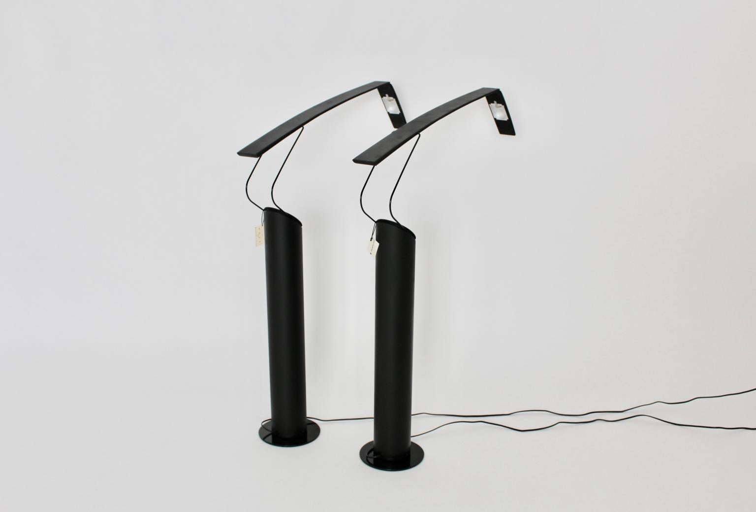 Black metal vintage set of two halogen floor lamps named Dove, which was designed by Mario Barbaglia and Marco Colombo, Italy 1980s and executed by Italian Luce.
The black table lamps rotate on the base (approximate 19 cm diameter) and the arms with