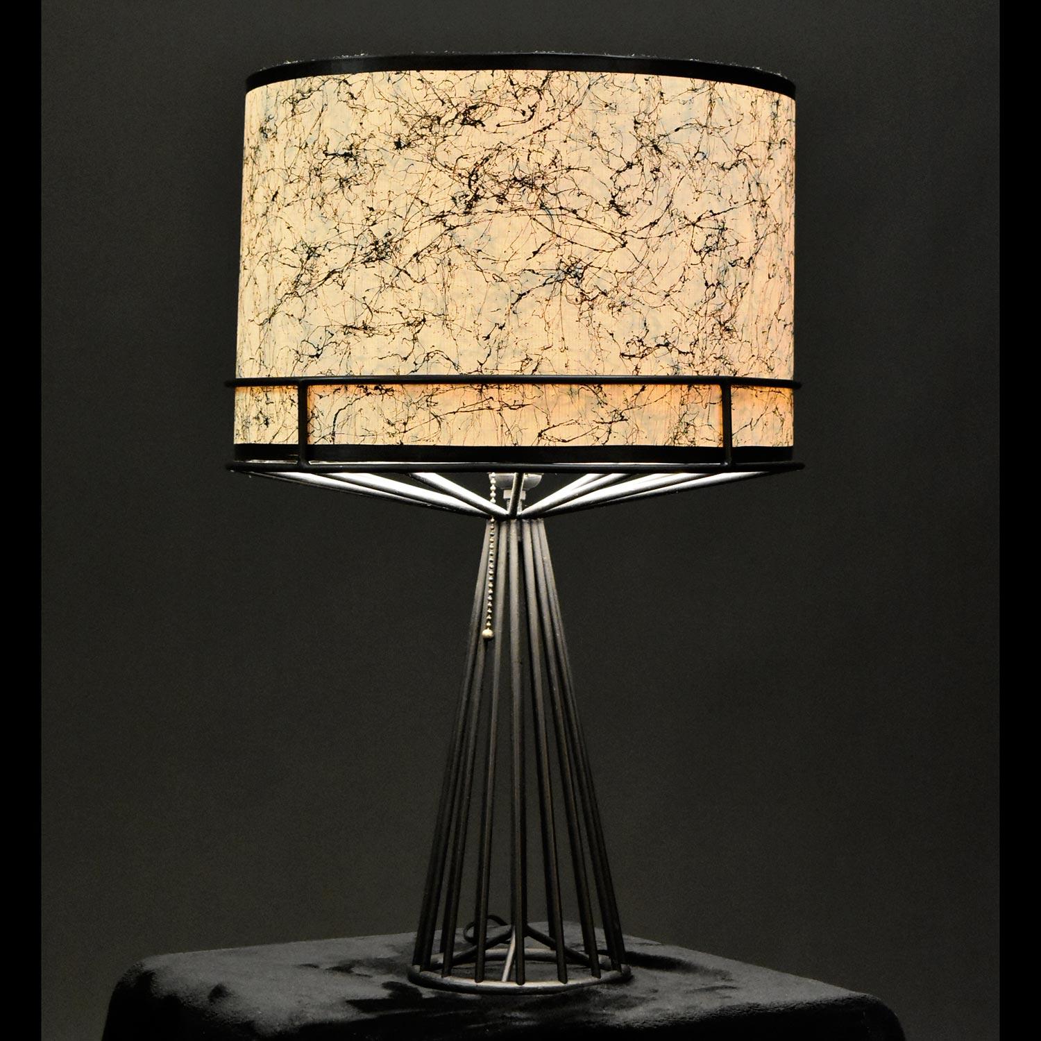 With a magic wand, we couldn't create a more perfect drum shade to compliment this lamp. Similar in style to the works of Warren Platner, architectural spires of metal wire reach upward to shape an obelisk cone. From its neck, more spires