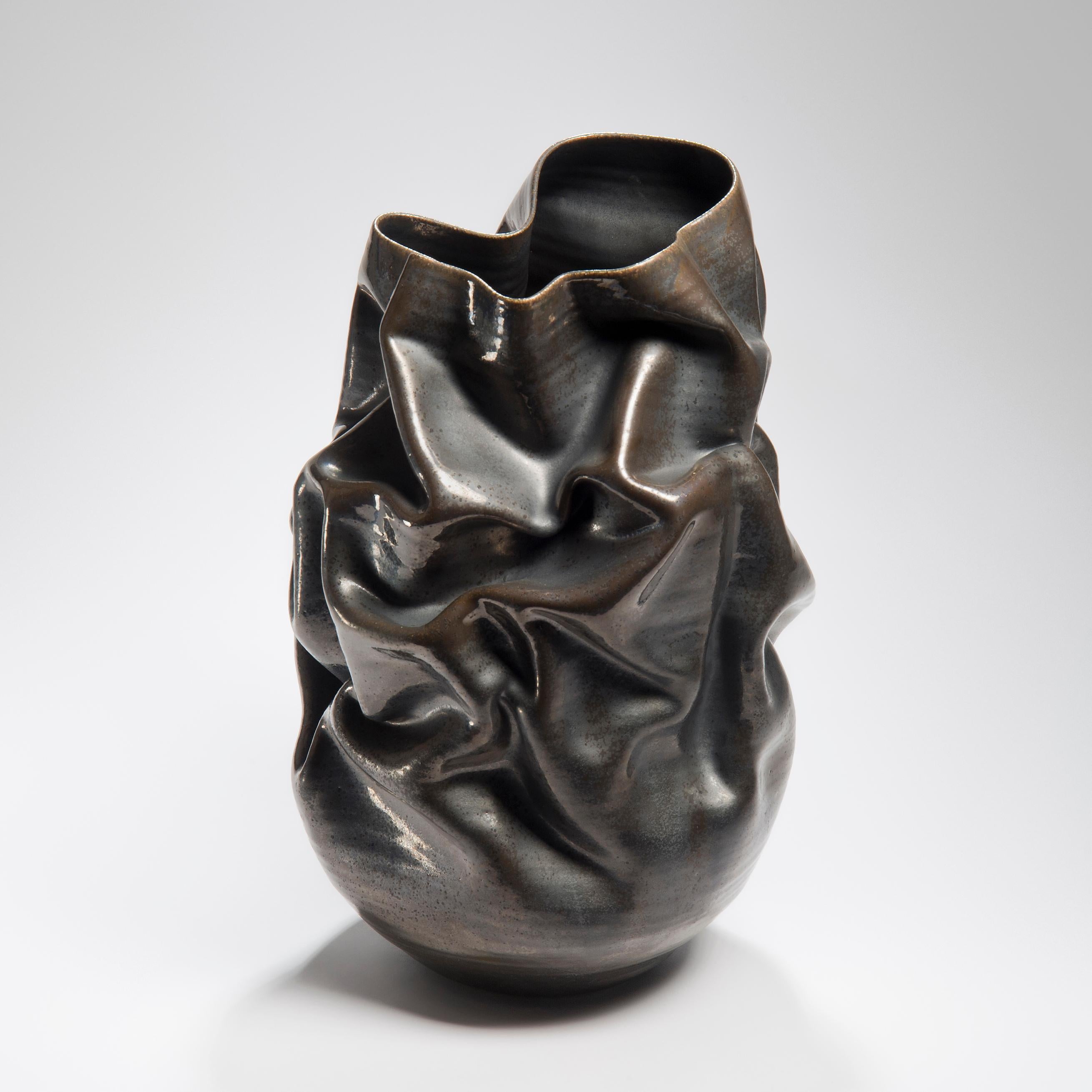 Black Metallic Crumpled Form No 32 is a unique ceramic sculptural vessel by the British artist Nicholas Arroyave-Portela.

Nicholas Arroyave-Portela’s professional ceramic practice began in 1994. After 20 years based in London, he moved and set up