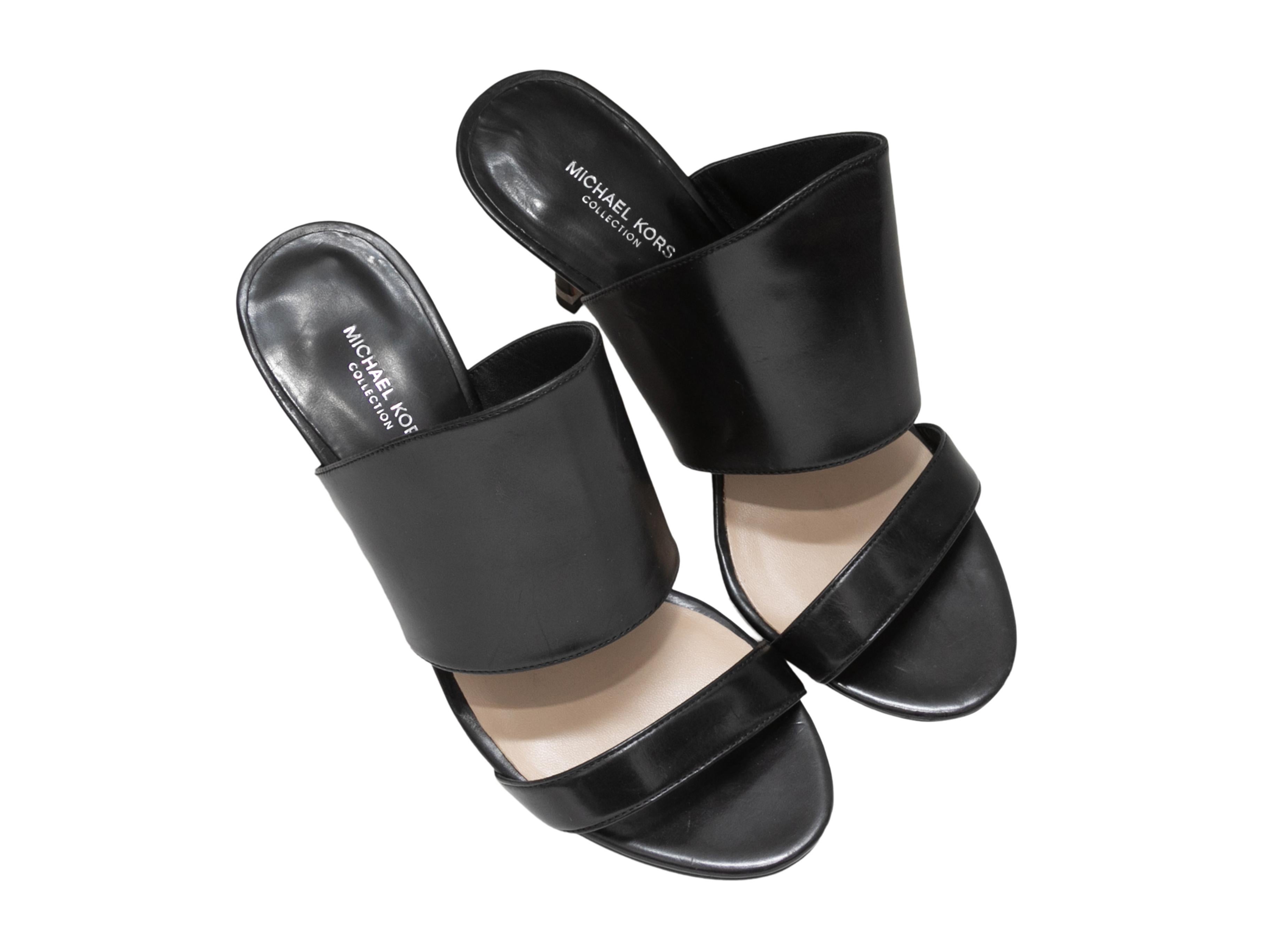 Black leather heeled slide sandals by Michael Kors. 3