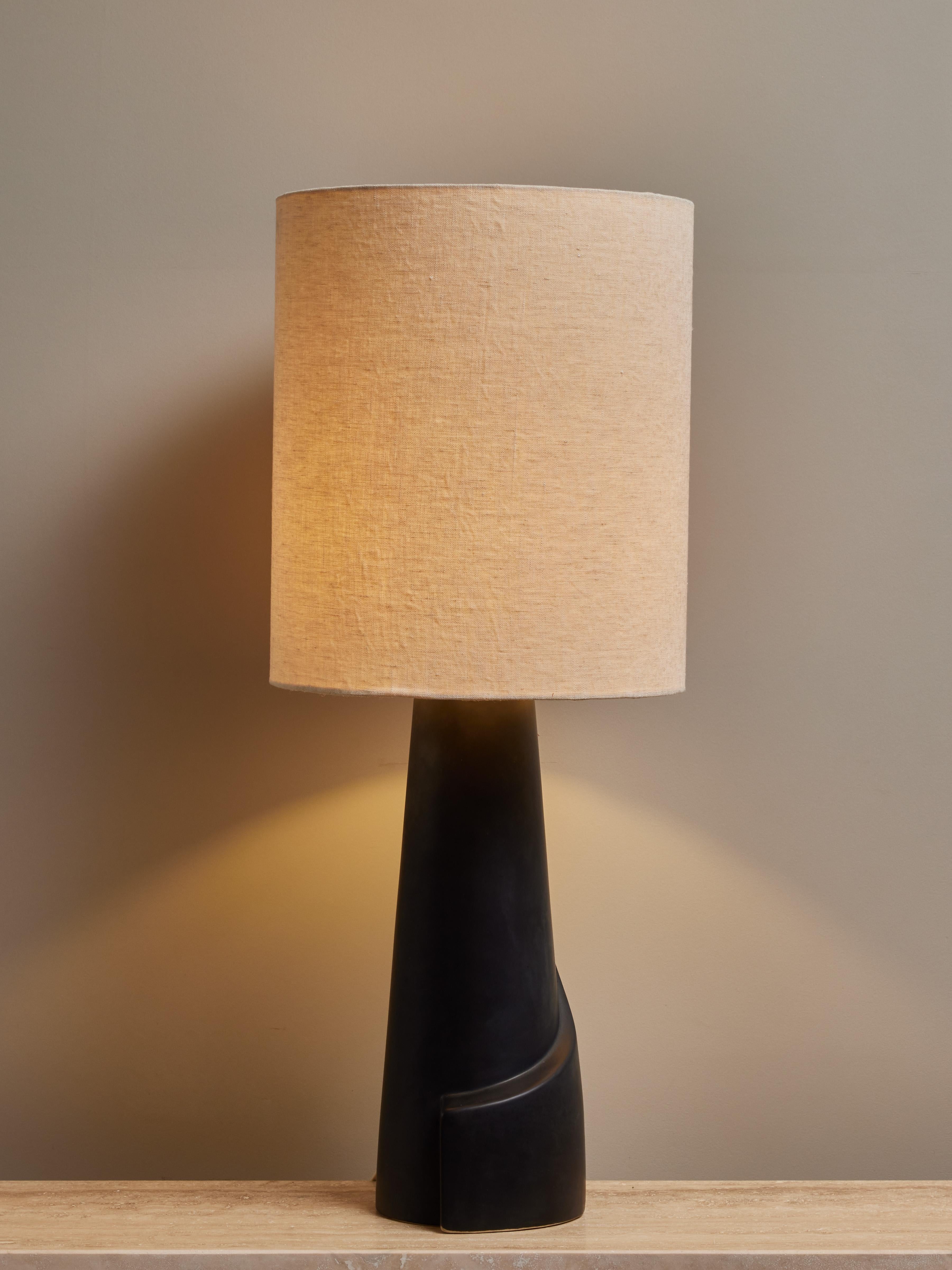 Mid century table lamp made of painted ceramic, with a twisted motif circling the base.