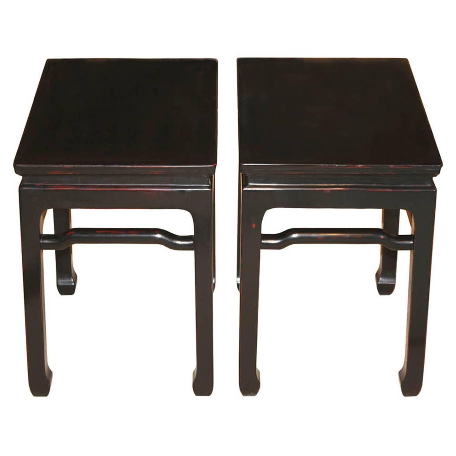 Contemporary Ming style table with support bars and horse hoof-style feet can be used as coffee tables, side tables or as extra sitting. Finish in black with red accents.