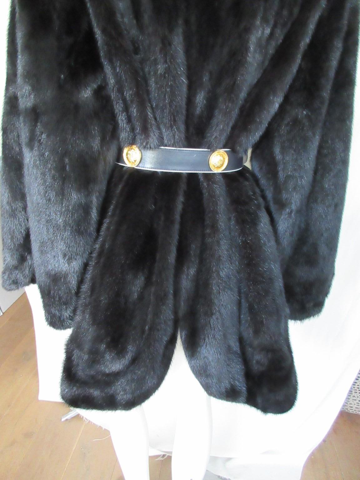 Black vintage mink fur coat, special model/design, rare to find.

We offer more black, white, brown mink fur items, view our frontstore.

Details:
With 2 pockets, 3 closing hooks, 
Wide sleeves
1 inside logo pocket
3/4 lenght
Wide model
Huge
