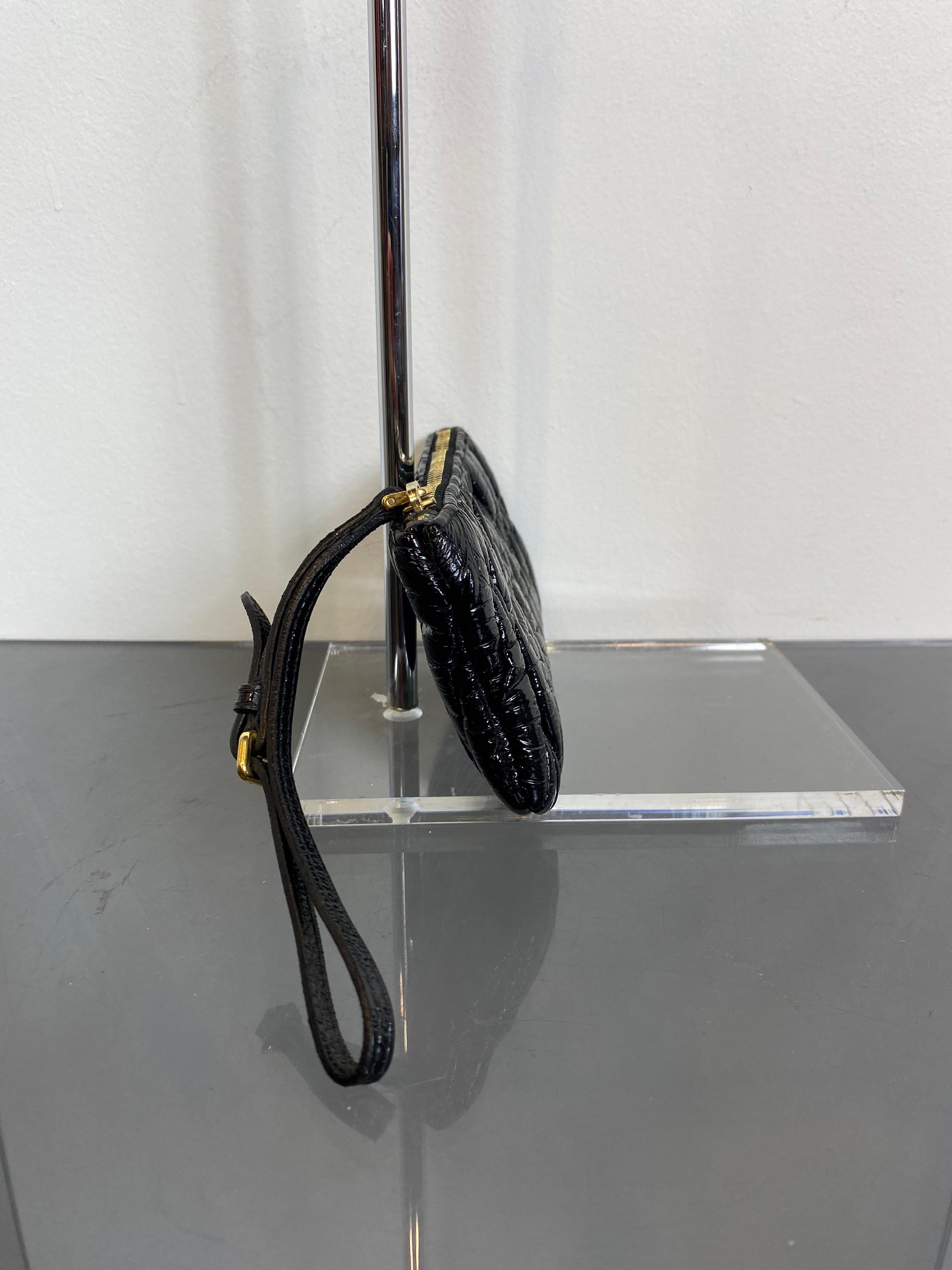 Black Miu Miu mini clutch bag in patent quilted leather with zip and gold details. 
In very good condition, only the inner lining has some marks. 
Width 16 cm
Height 9 cm 
Depth 2 cm 