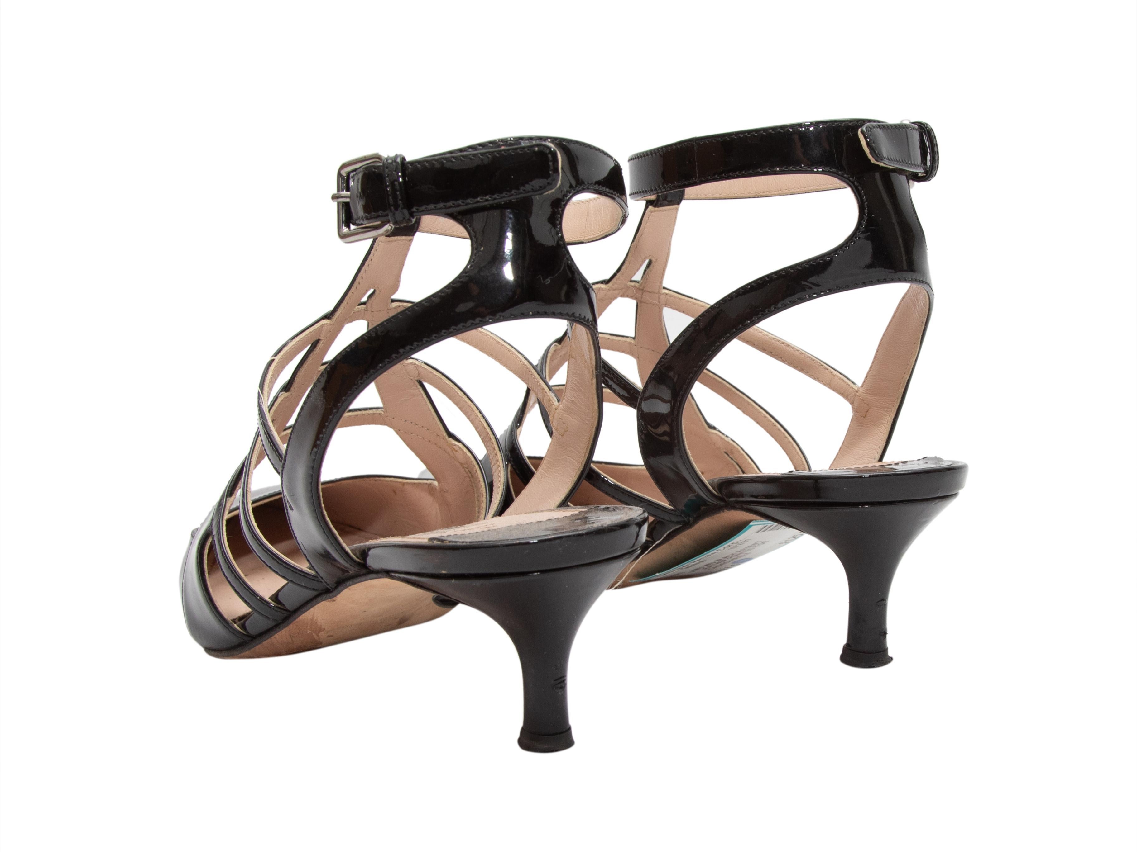 Black pointed-toe patent leather cage heels by Miu Miu. Kitten heels. Buckle closures at ankle straps. 2