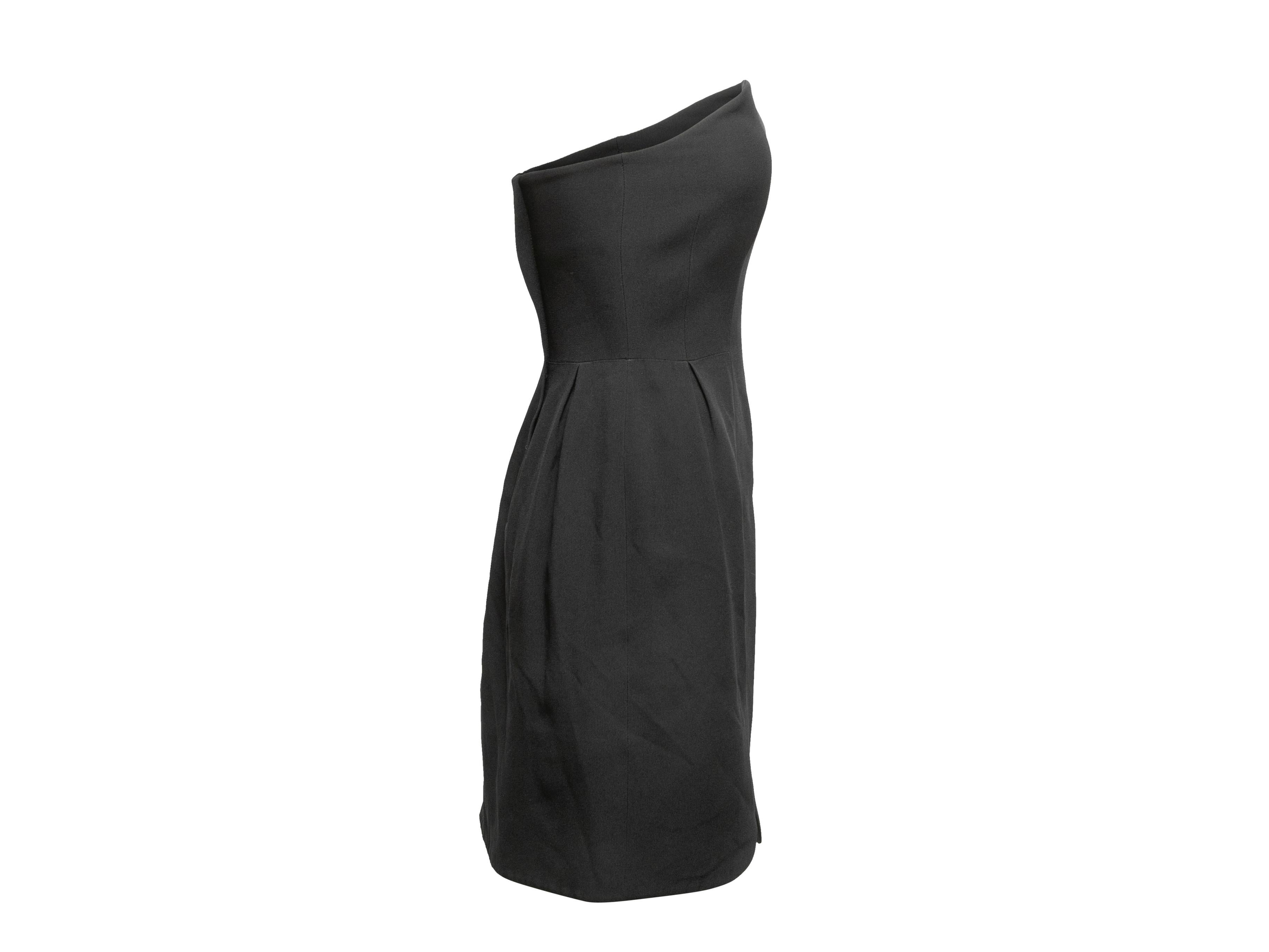 Black strapless mini dress by Miu Miu. Asymmetrical neckline. Back closures. 31