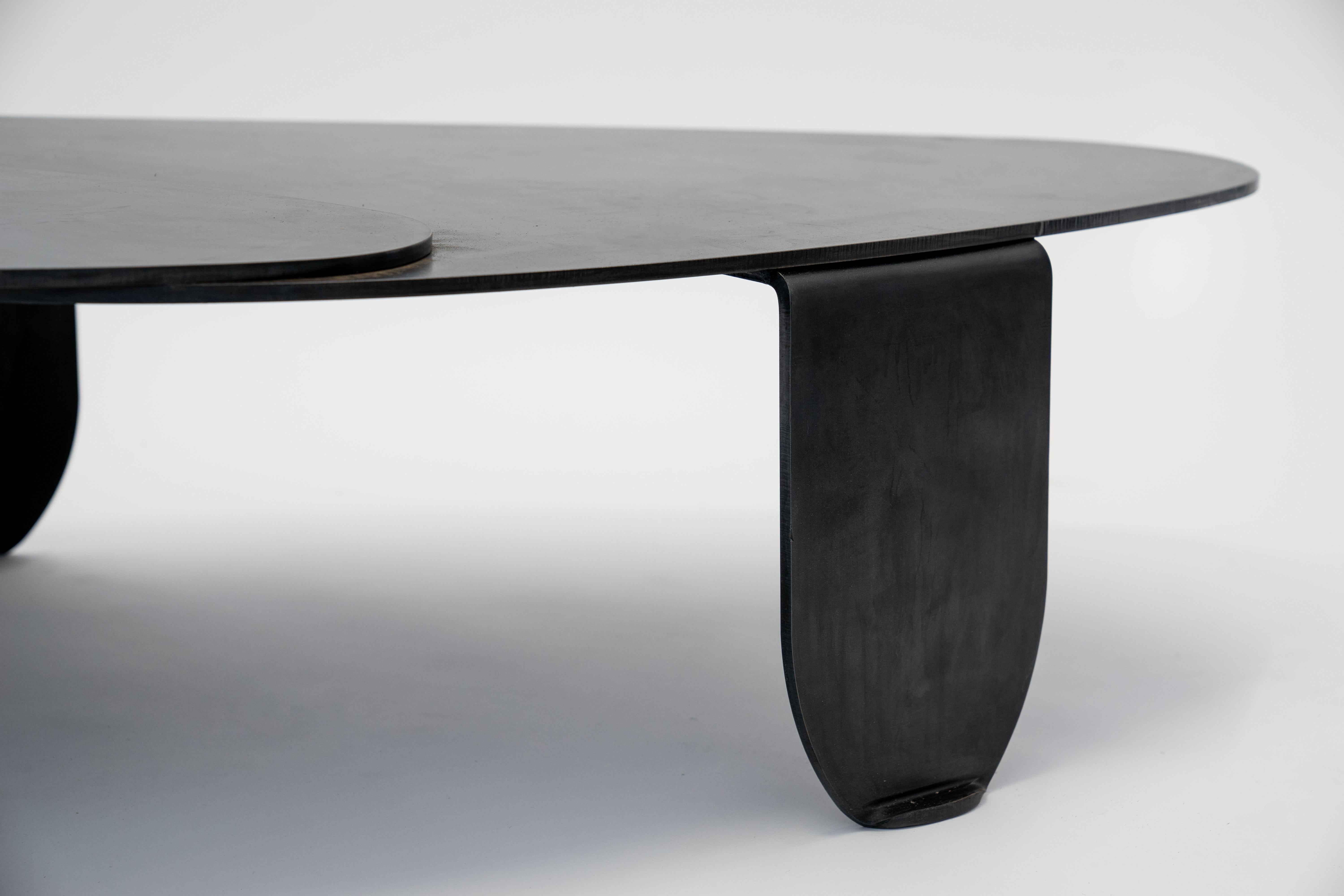 TABLE NO. 7 
J.M. Szymanski
d. 2018

Cut from ⅜” solid steel, these abstract shapes work together to create a contemporary design that is both unique and luxurious. Finished with a natural black patina and wax. 

Custom sizes available. Made in the