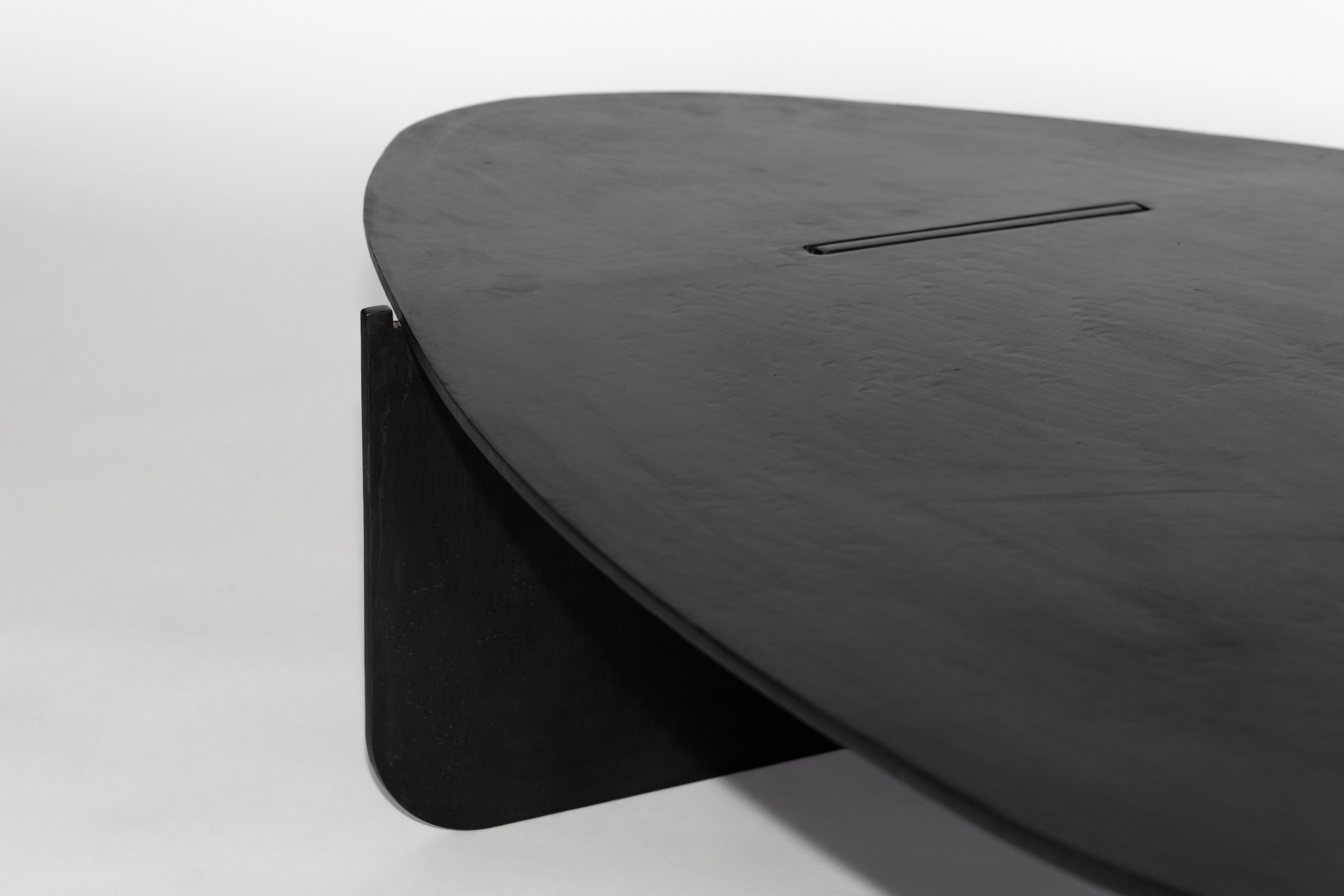 TABLE NO. 15 - COFFEE TABLE 
J.M. Szymanski
d. 2019

This Noguchi-inspired coffee table is handcrafted in 3/8” thick steel, with a natural black patina and wax finish, to create an ulta-modern and inspired look. 

Custom sizes available. Made in the