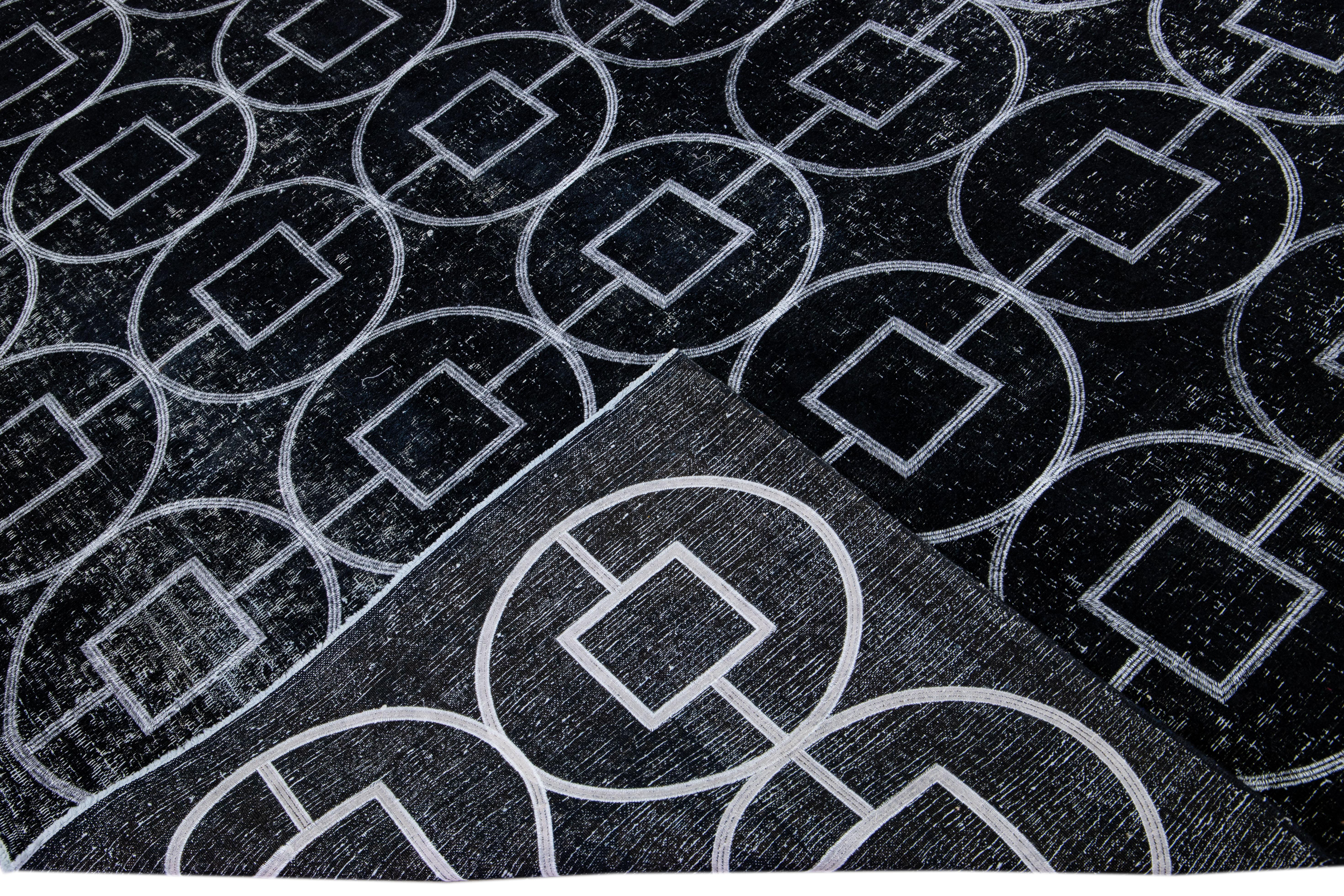 Beautiful Turkish handmade wool rug with a black distress look field. This Modern rug has white accents featuring a gorgeous all-over geometric pattern design.

This rug measures: 10' x 12'6.

Our rugs are professional cleaning before shipping.