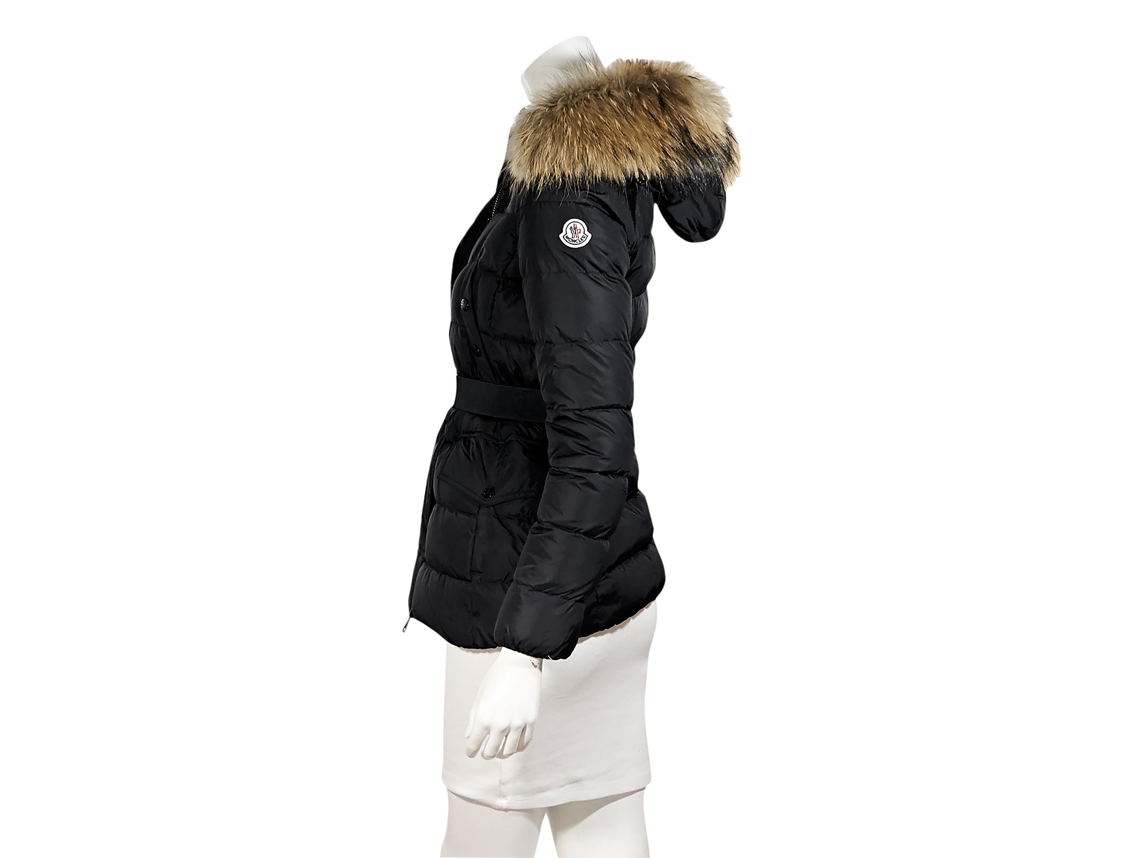 Product details:  Black Clio puffer coat by Moncler.  Fur-trimmed hood.  Long sleeves.  Snap placket over zip-front closure.  Snap chest pockets.  Waist snap flap pockets.  Belted waist.  Moncler size 00.  29