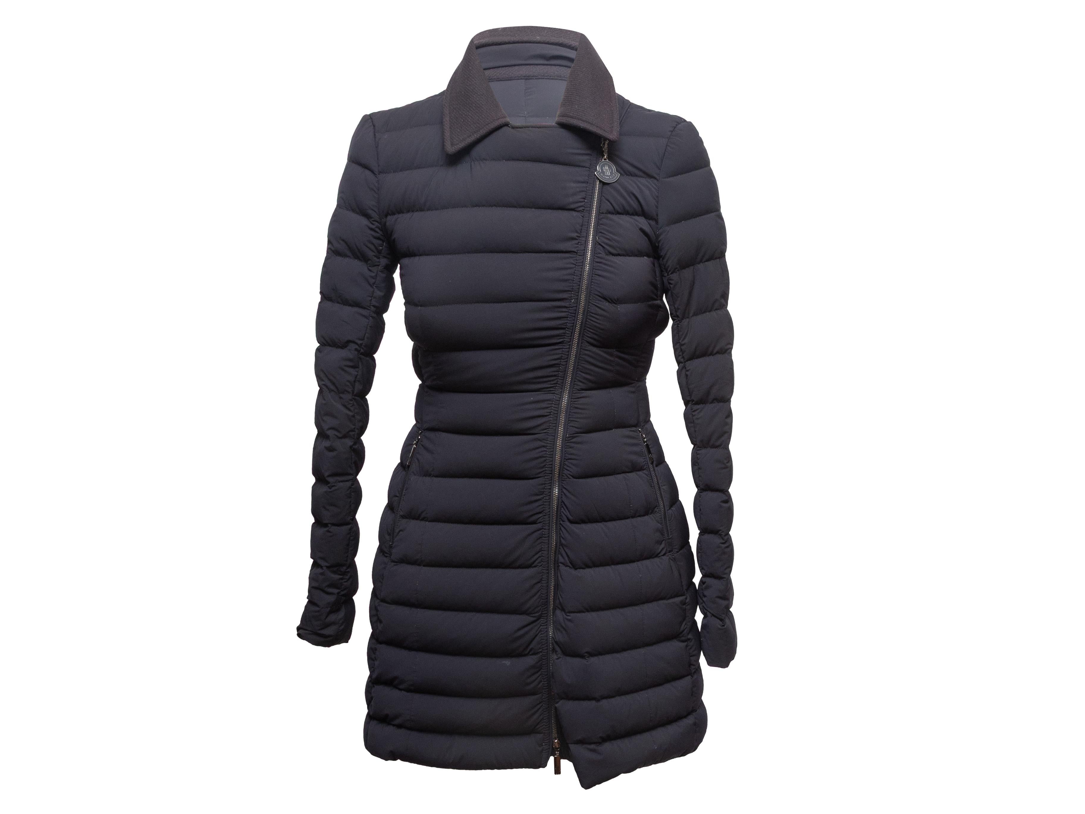 Black collared down puffer coat by Moncler. Notched collar. Dual zip closure hip pockets. Front zip closure. 32