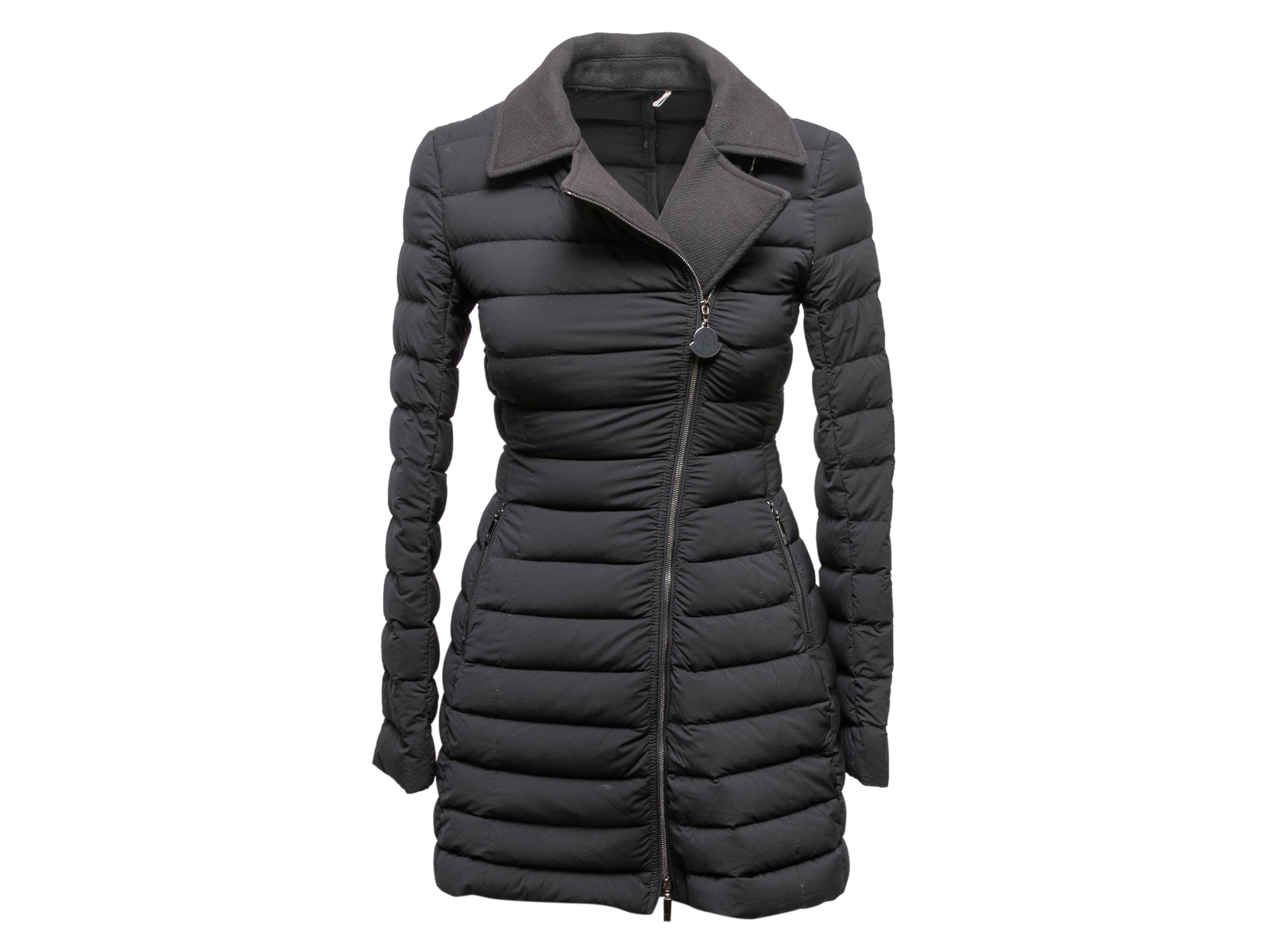 Black quilted nylon and virgin wool-trimmed jacket by Moncler. Notched lapel. Dual hip pockets. Asymmetrical front zip closure. 28