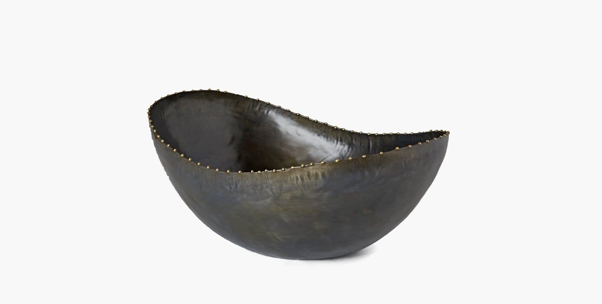 Our Montana Bowls effortlessly elevate your home décor, featuring organic curves in ebonized iron with subtle metal detailing to highlight its serpentine edge. Our handcrafted finishes are inspired by variations within natural textures. Each
