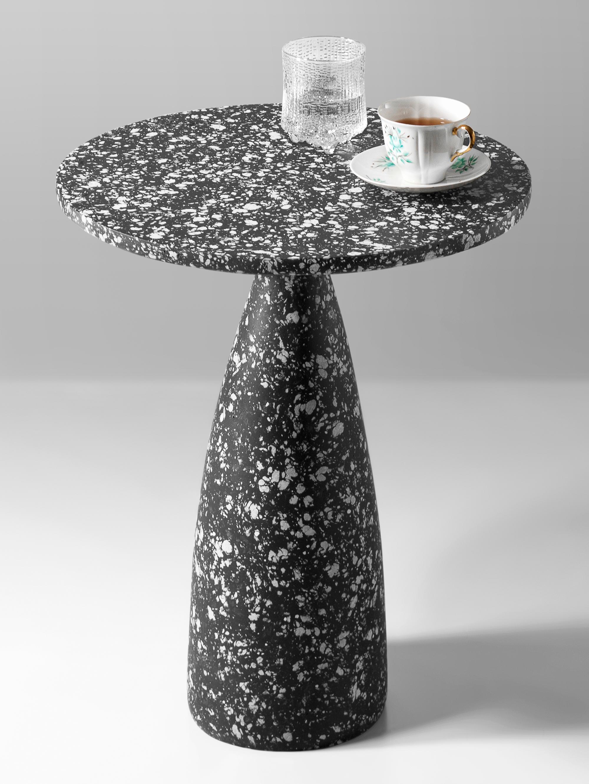Black Mottled Side Table 40 by Kasanai
Dimensions: D 40 x H 50 cm.
Materials: Cement, recycled paper, glue, paint.
8 kg.

The fusion of sturdiness and elegance, along with the blend of archaism and modernity. More than just a surface for placing