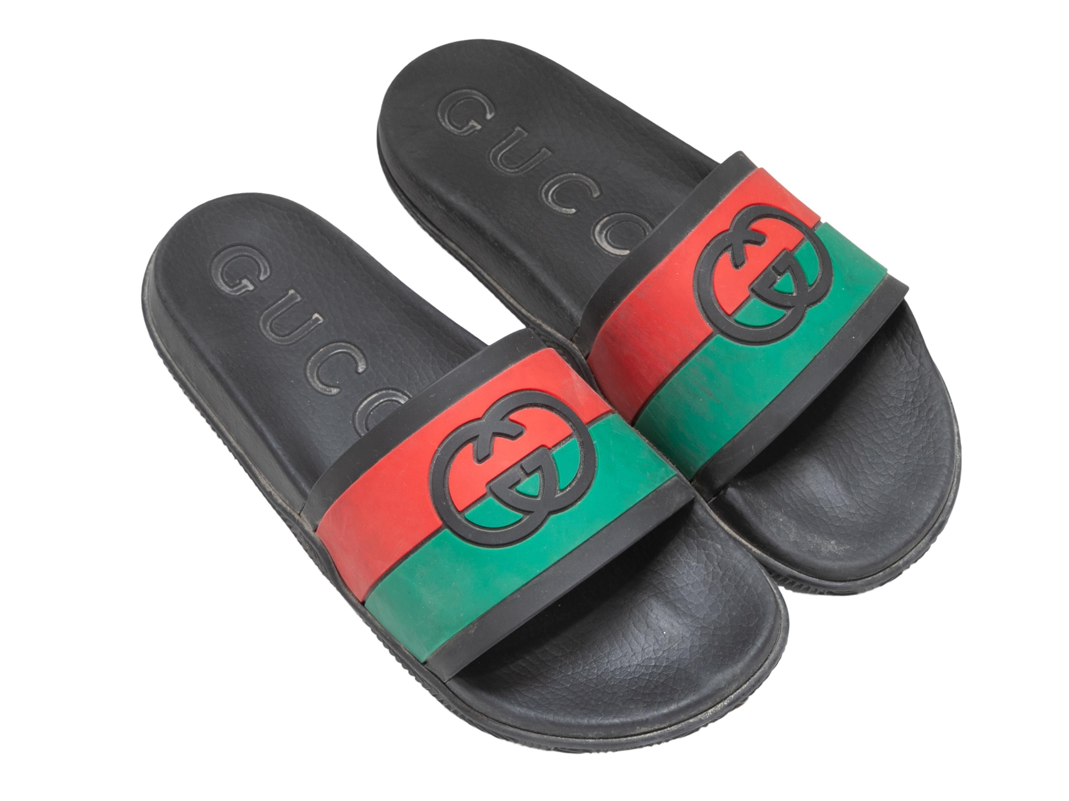  Black, green, and red rubber men's slide sandals by Gucci. GG logos at tops. 0.75