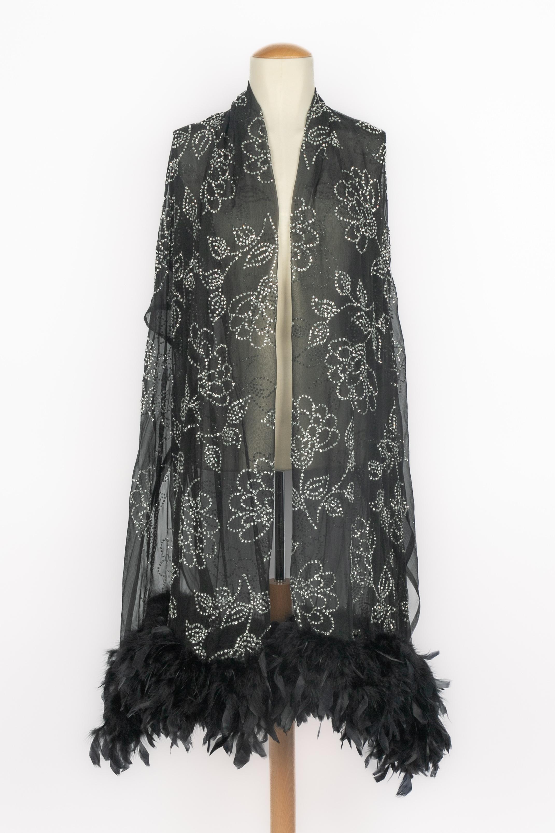 UNBEKANNT - Lange schwarze Musselinstola mit Strasssteinen und Federn. Stück aus den 1950er Jahren.

Bedingung:
Sehr guter Zustand

Abmessungen:
Breite: 110 cm - Länge: 200 cm

SKU:ACC101


