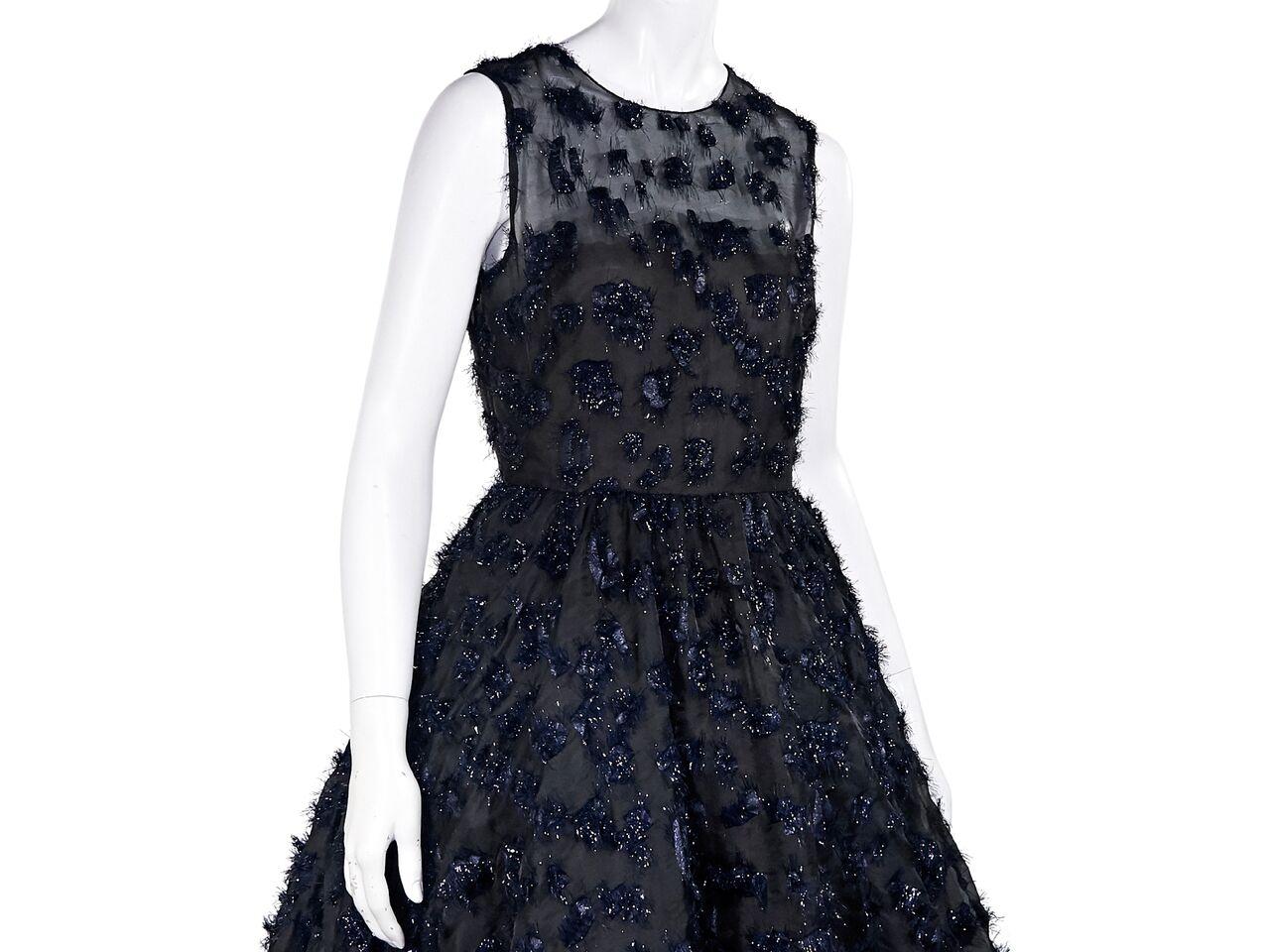 Product details:  Black and navy blue fil coupe cocktail dress by Oscar de la Renta.  Roundneck.  Sleeveless.  Inner bodice straps for support.  Back keyhole cutout with button closure.  A-line skirt.  Concealed back zip closure.  36