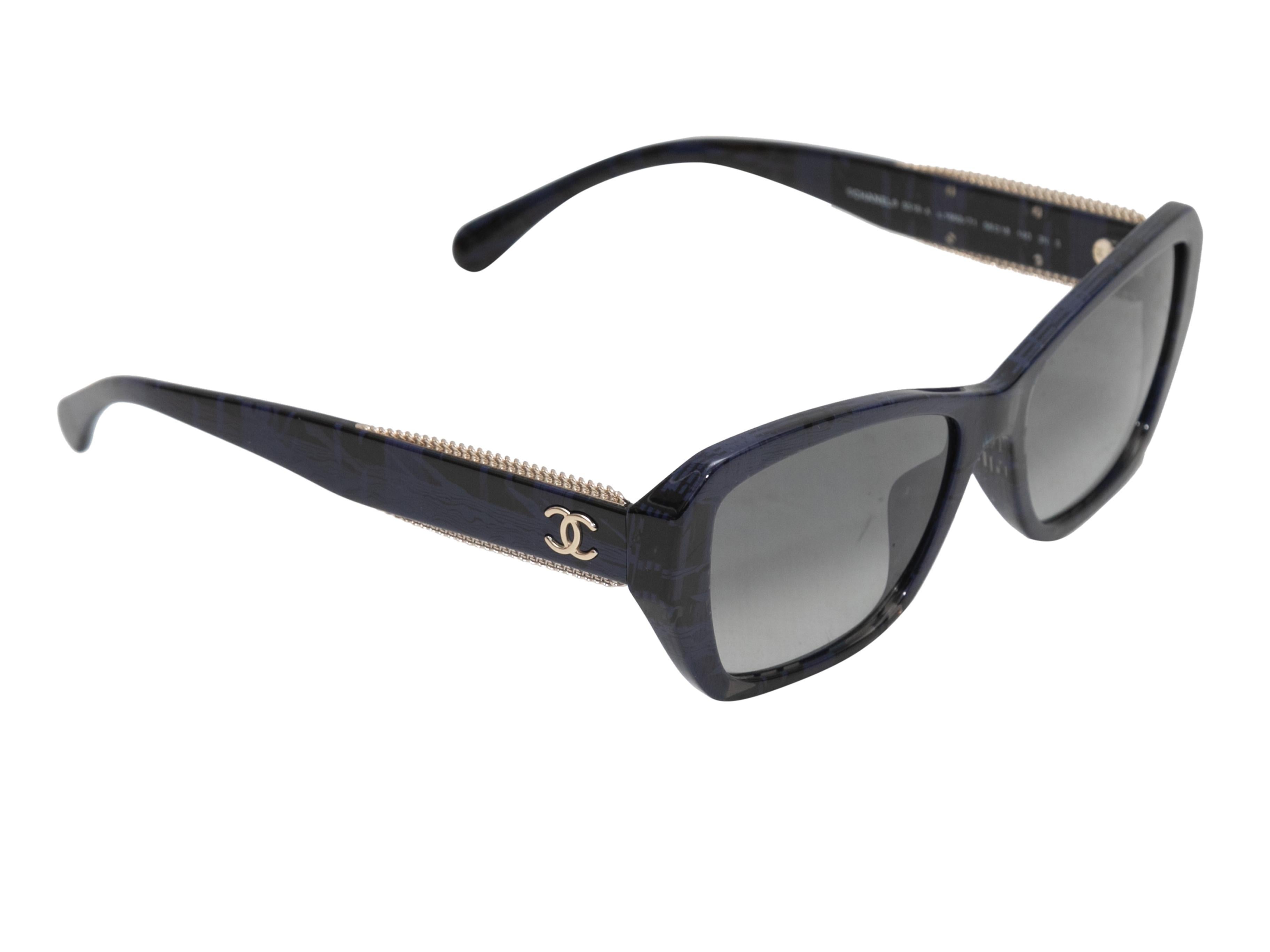 Black and navy printed acetate sunglasses by Chanel. Silver-tone chain-link embellishments at arms. Grey tinted lenses. 2