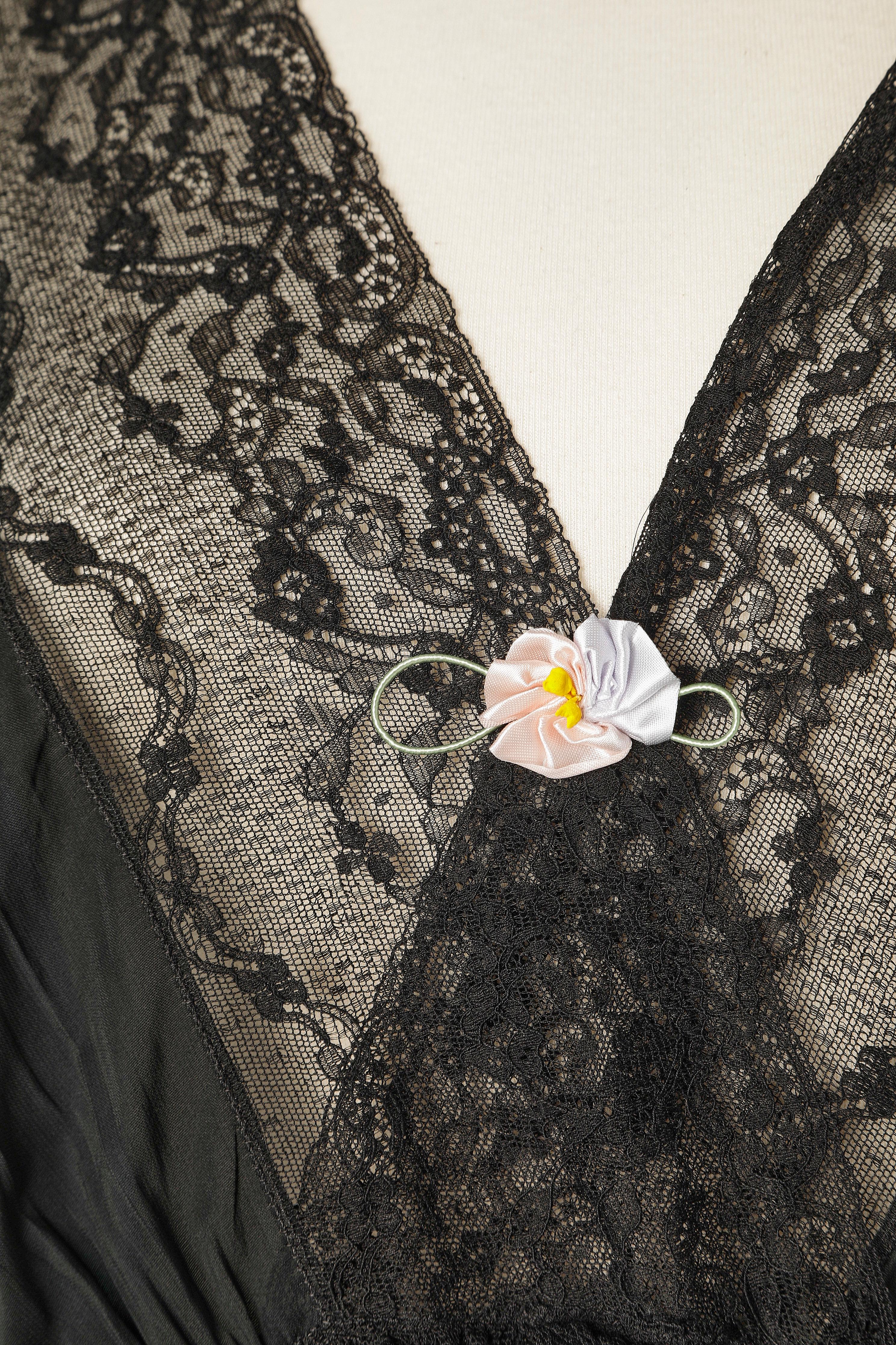 Black night gown with lace insert and satin flower in the middle front. No fabric tag, probably nylon. 
SIZE M 